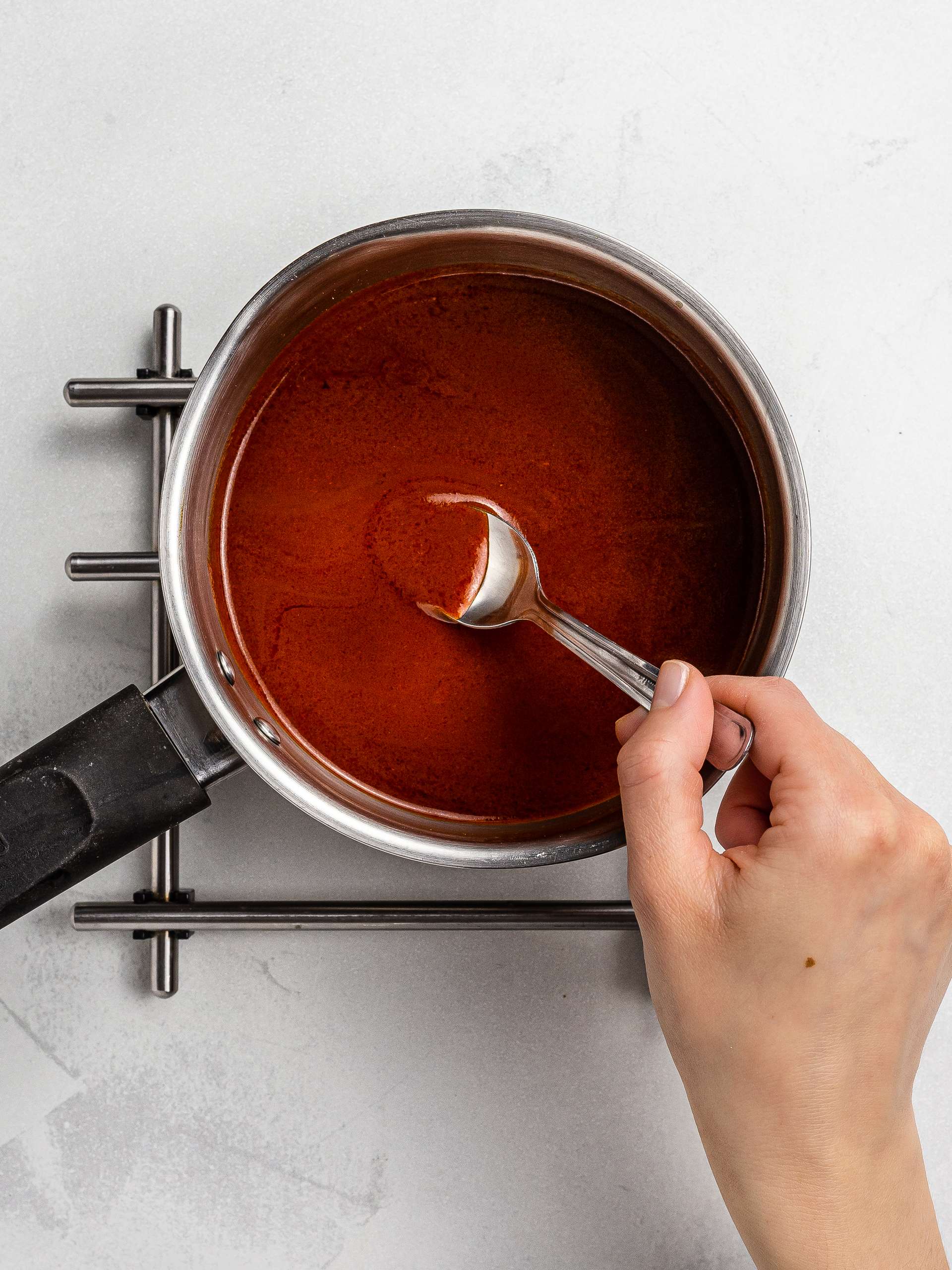 buffalo sauce thickened in a pot with starch