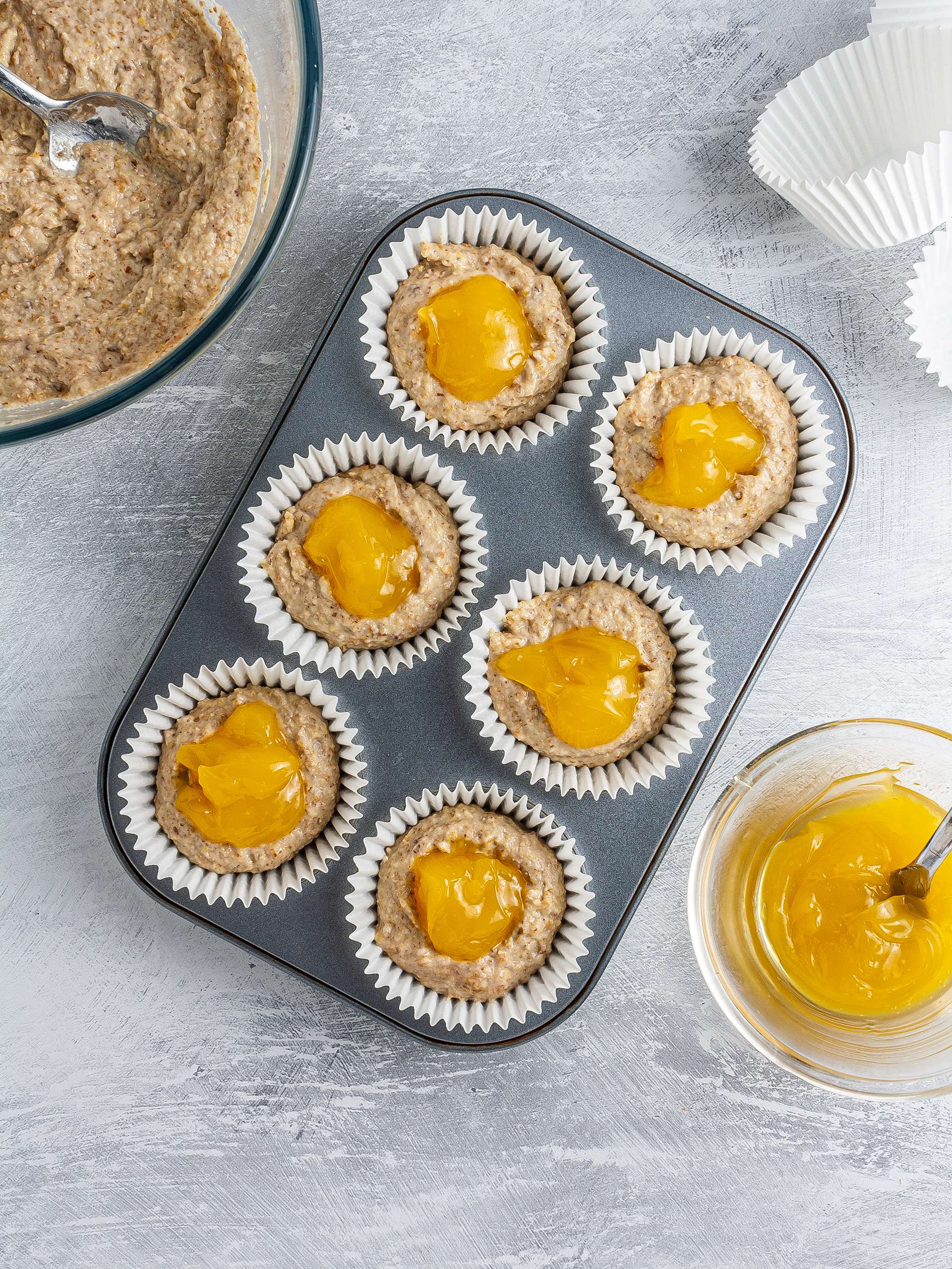 Muffin batter in cases with lemon curd