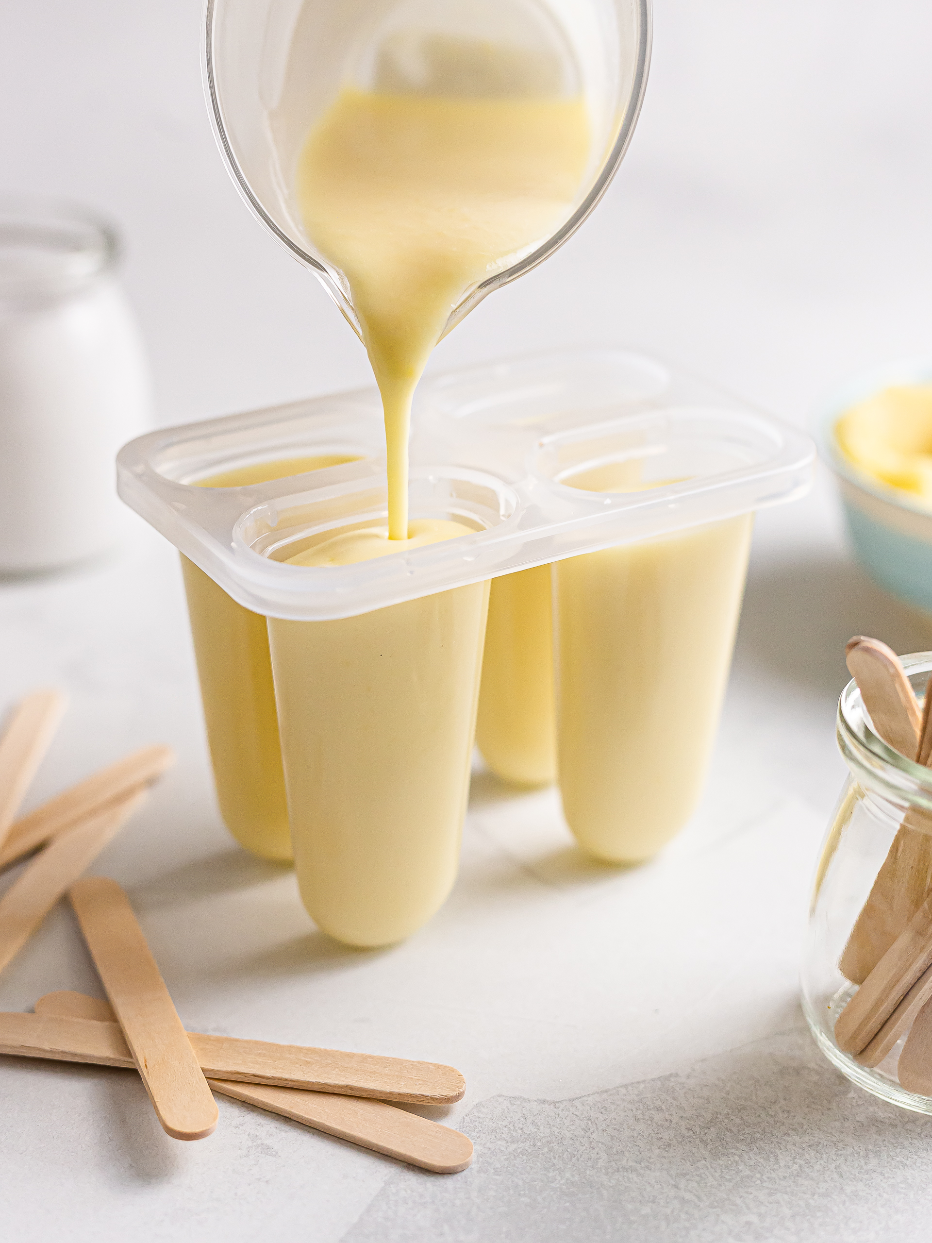 yellow mung bean ice cream batter poured into popsicle moulds