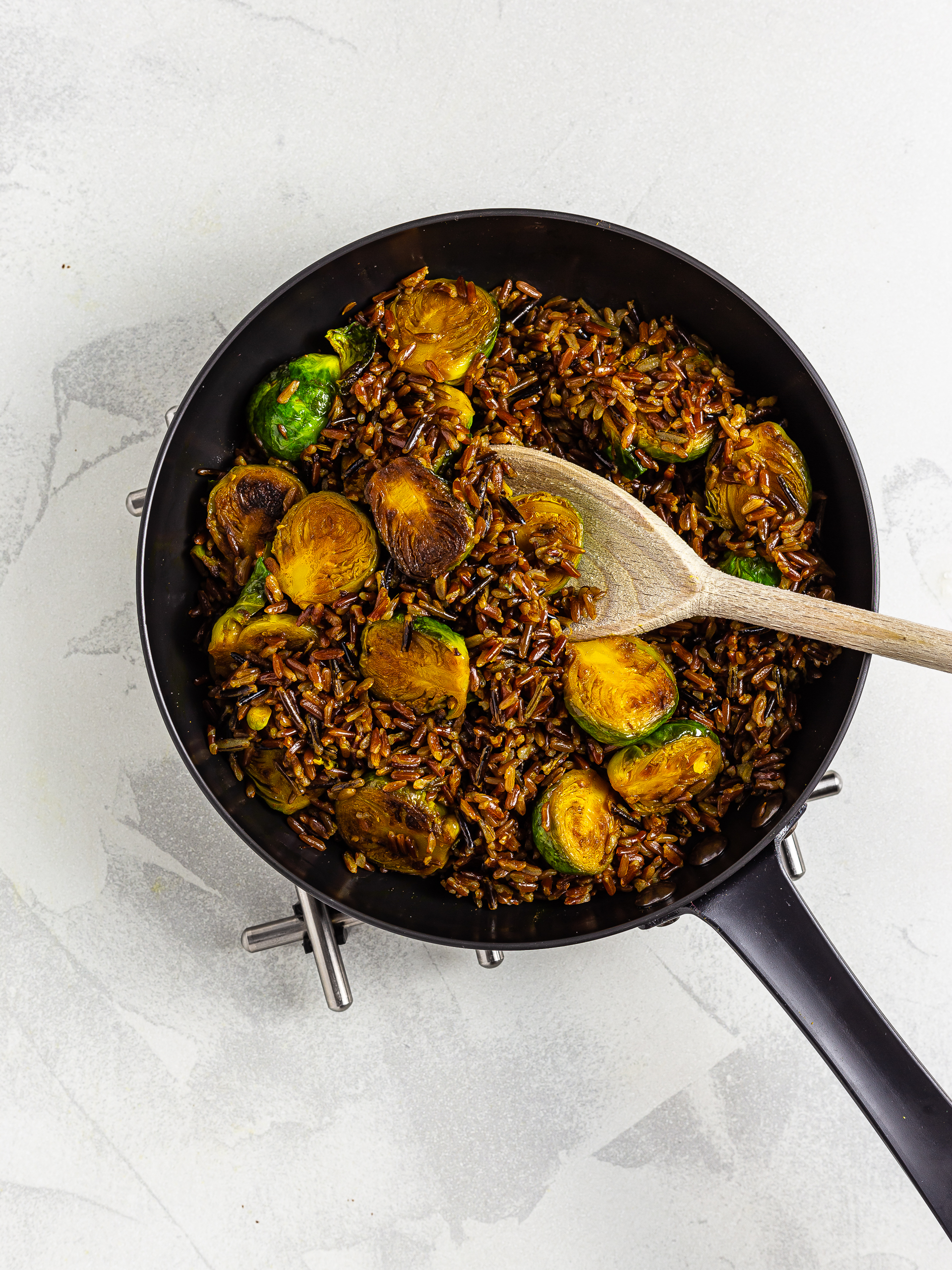 red rice with brussel sprouts in a skillet