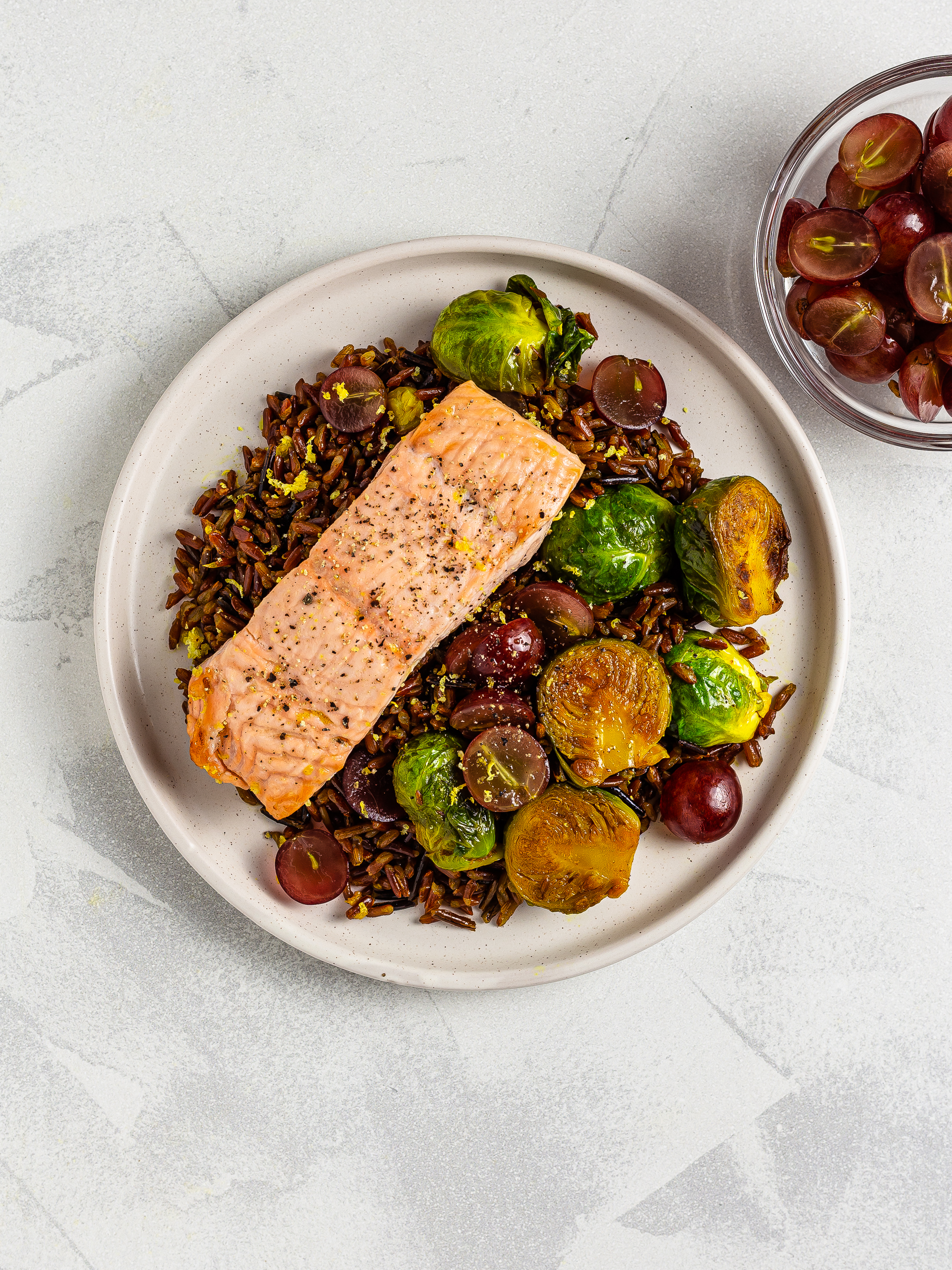 salmon with red rice and grapes salad