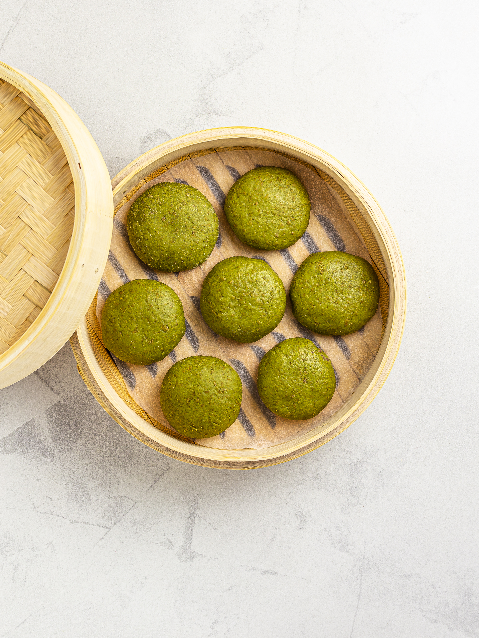 matcha manju in a steaming basket