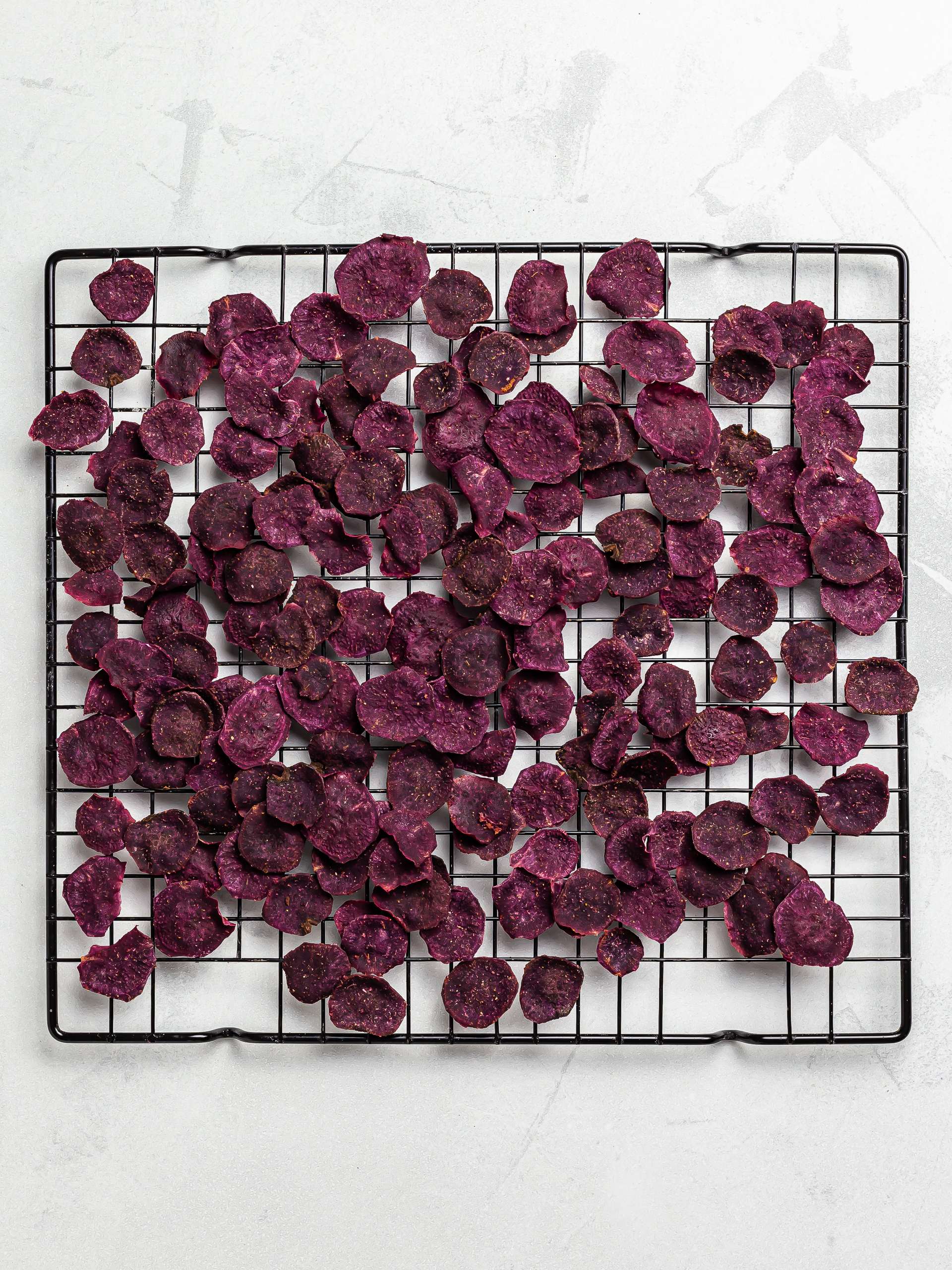 oven baked purple sweet potato chips on a rack