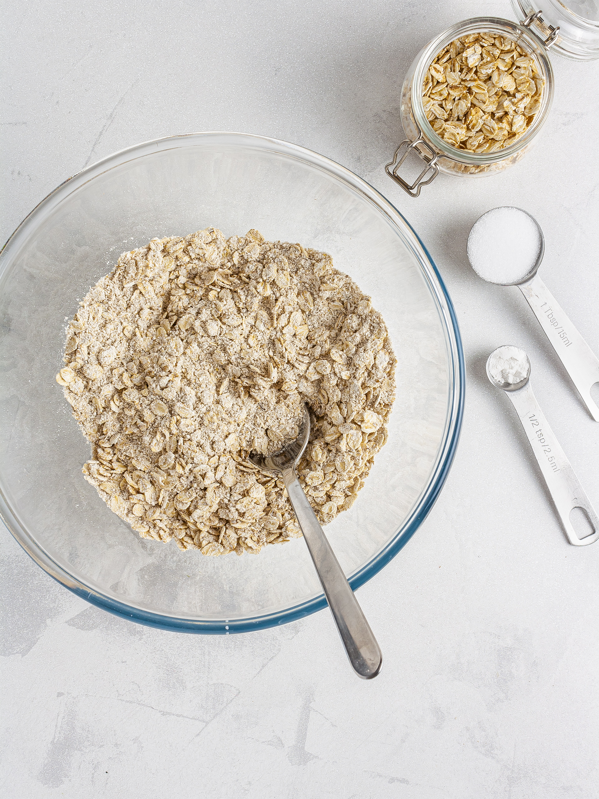 Oat flour, oat flakes, erythritol, and baking powder in a bowl