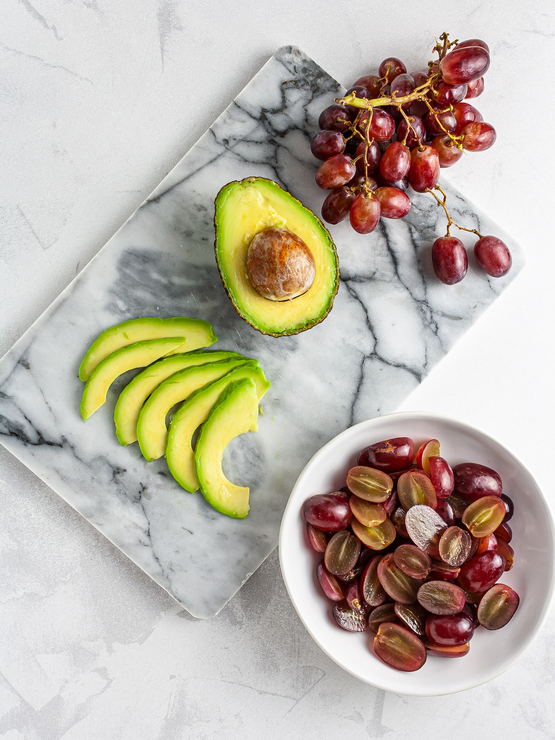 Halved grapes and sliced avocado