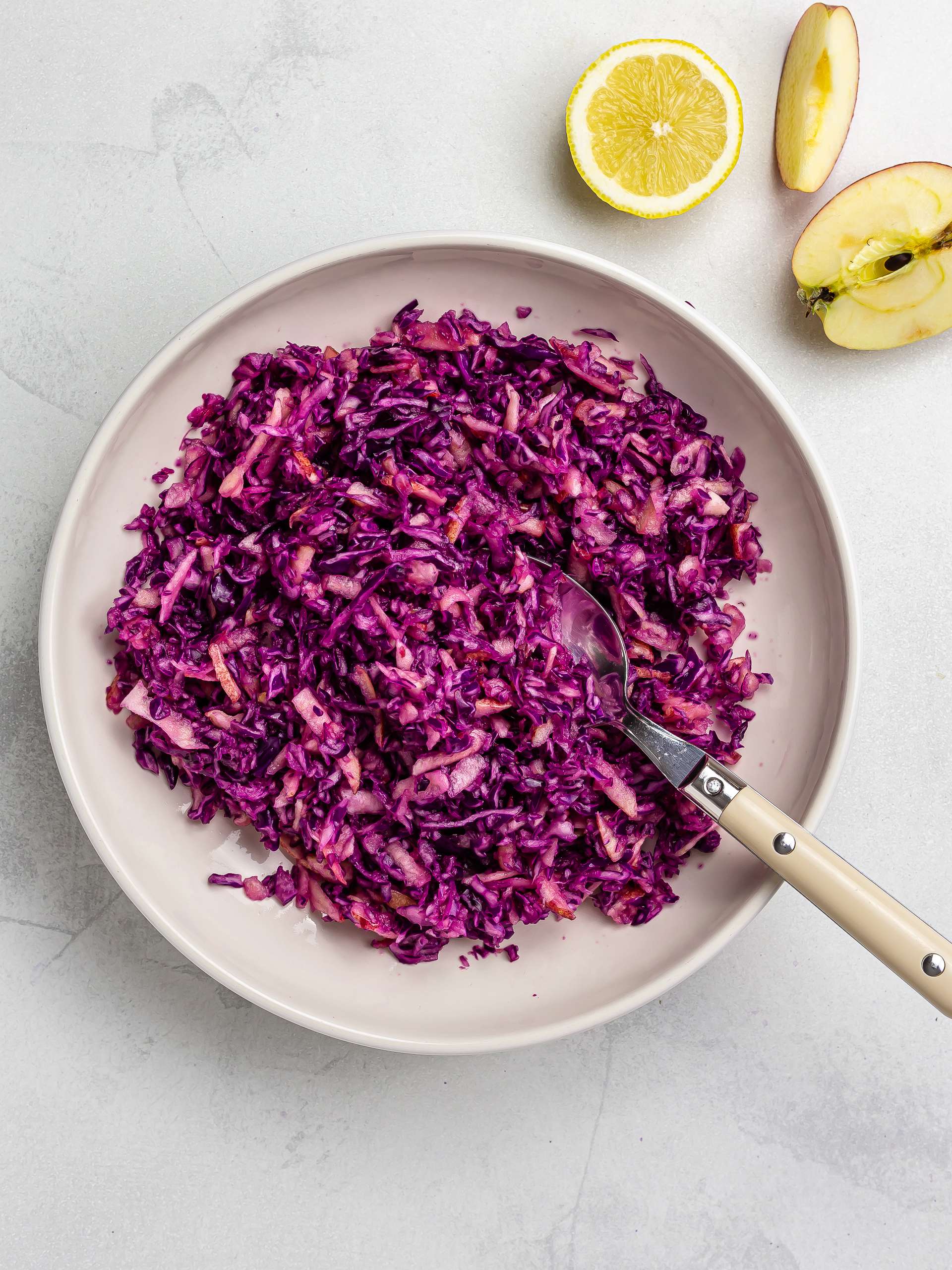 shredded red cabbage with grated apple and lemon
