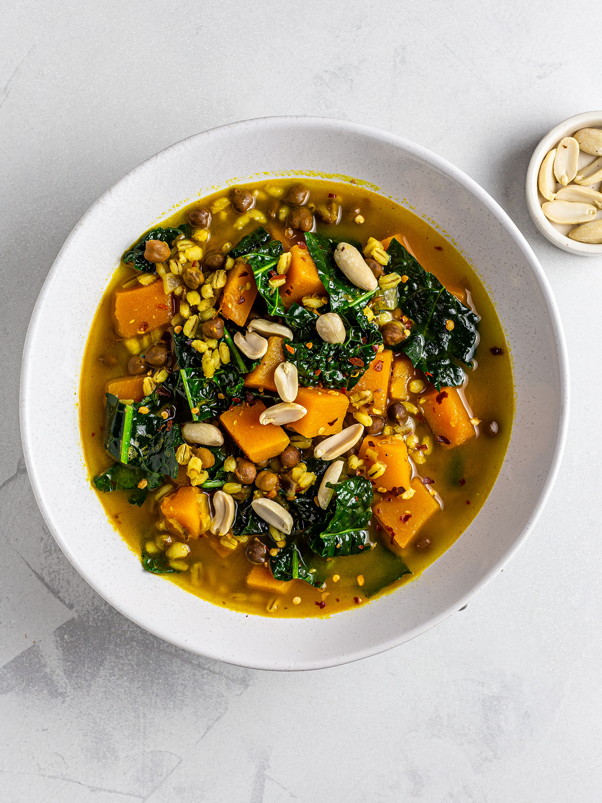 Pumpkin kale soup with roasted peanuts