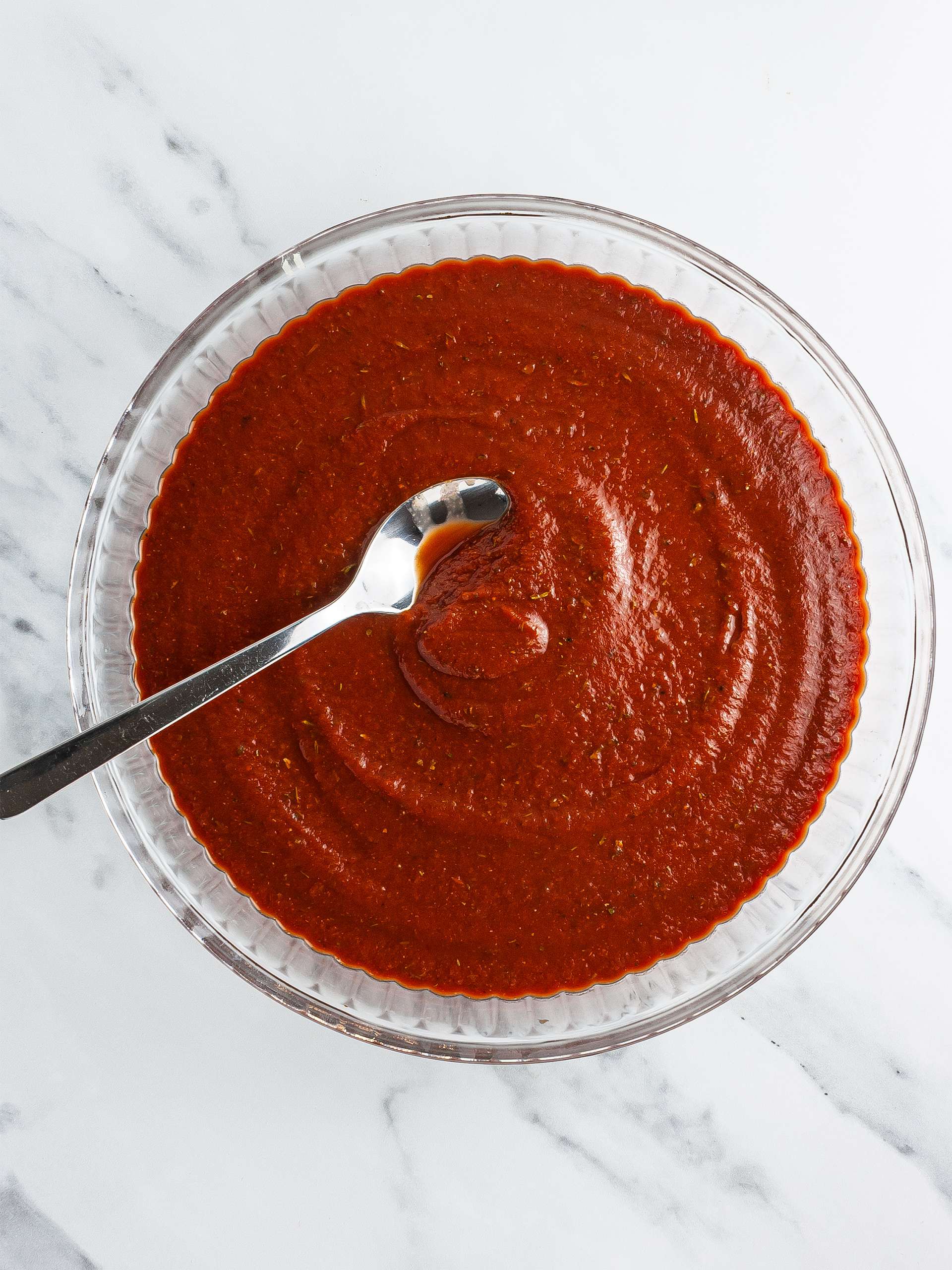 Tomato sauce spread over a baking dish
