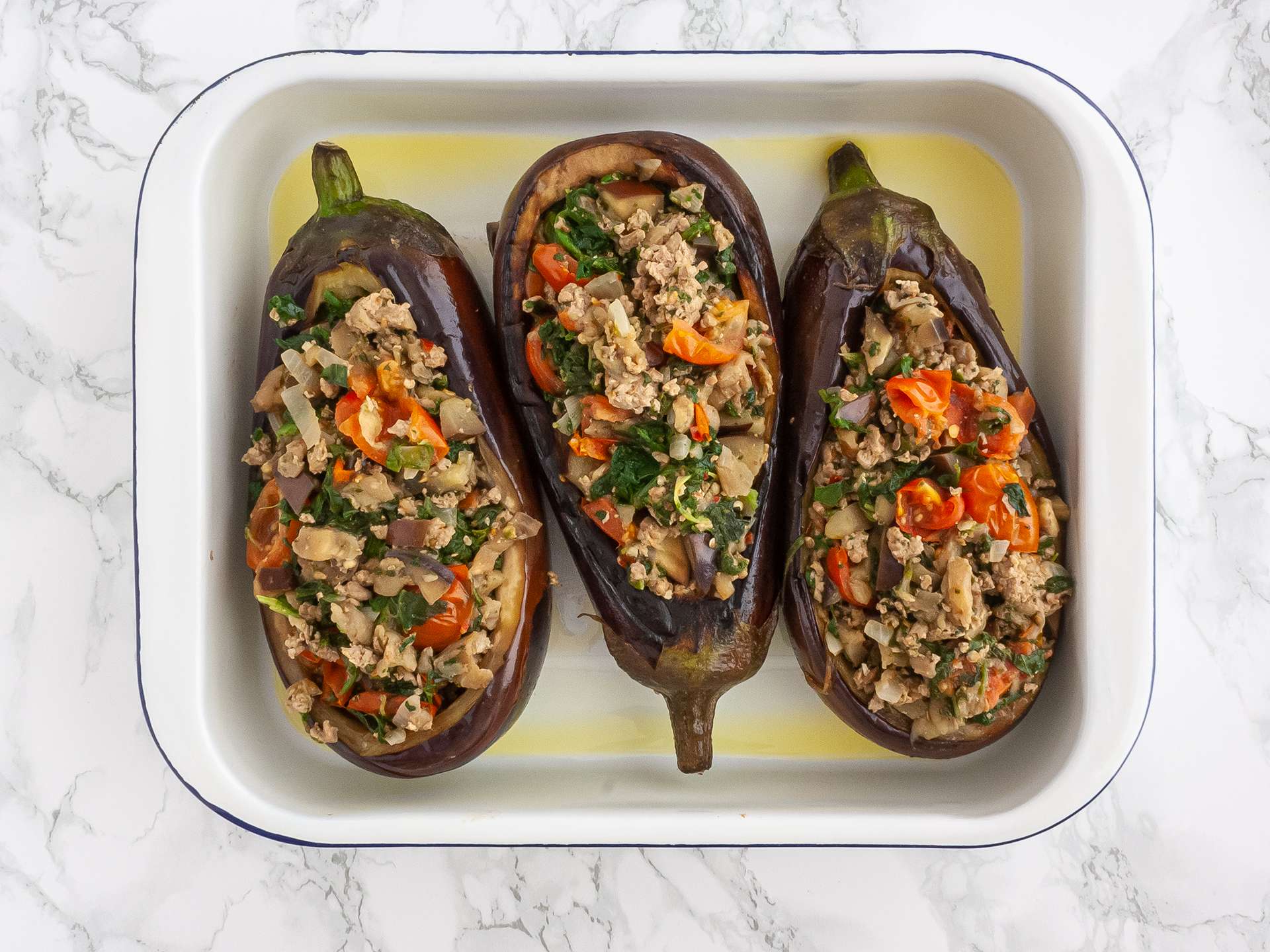 Aubergines stuffed with ketogenic filling into a roasting tin