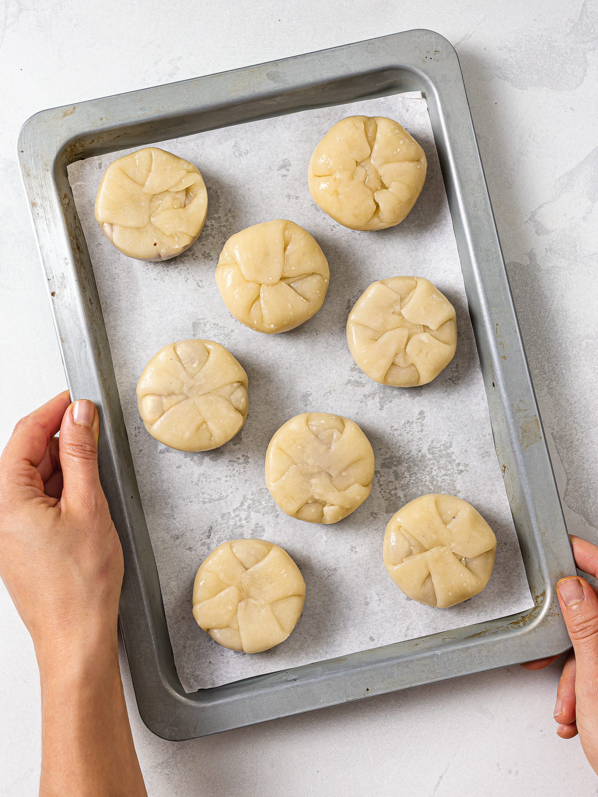 hopia cakes on a baking tray seam side up