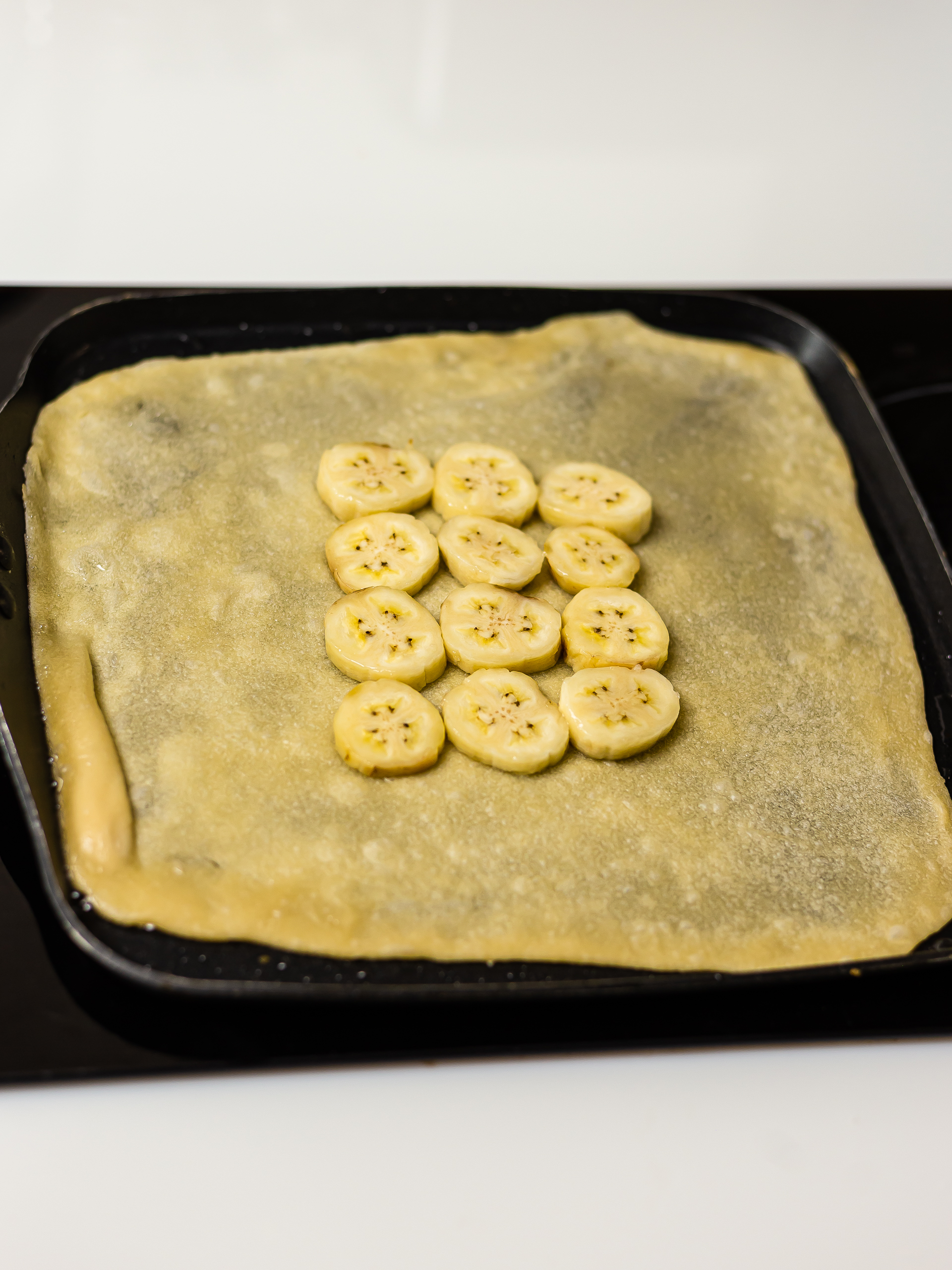 thai pancake with banana slices in a pan