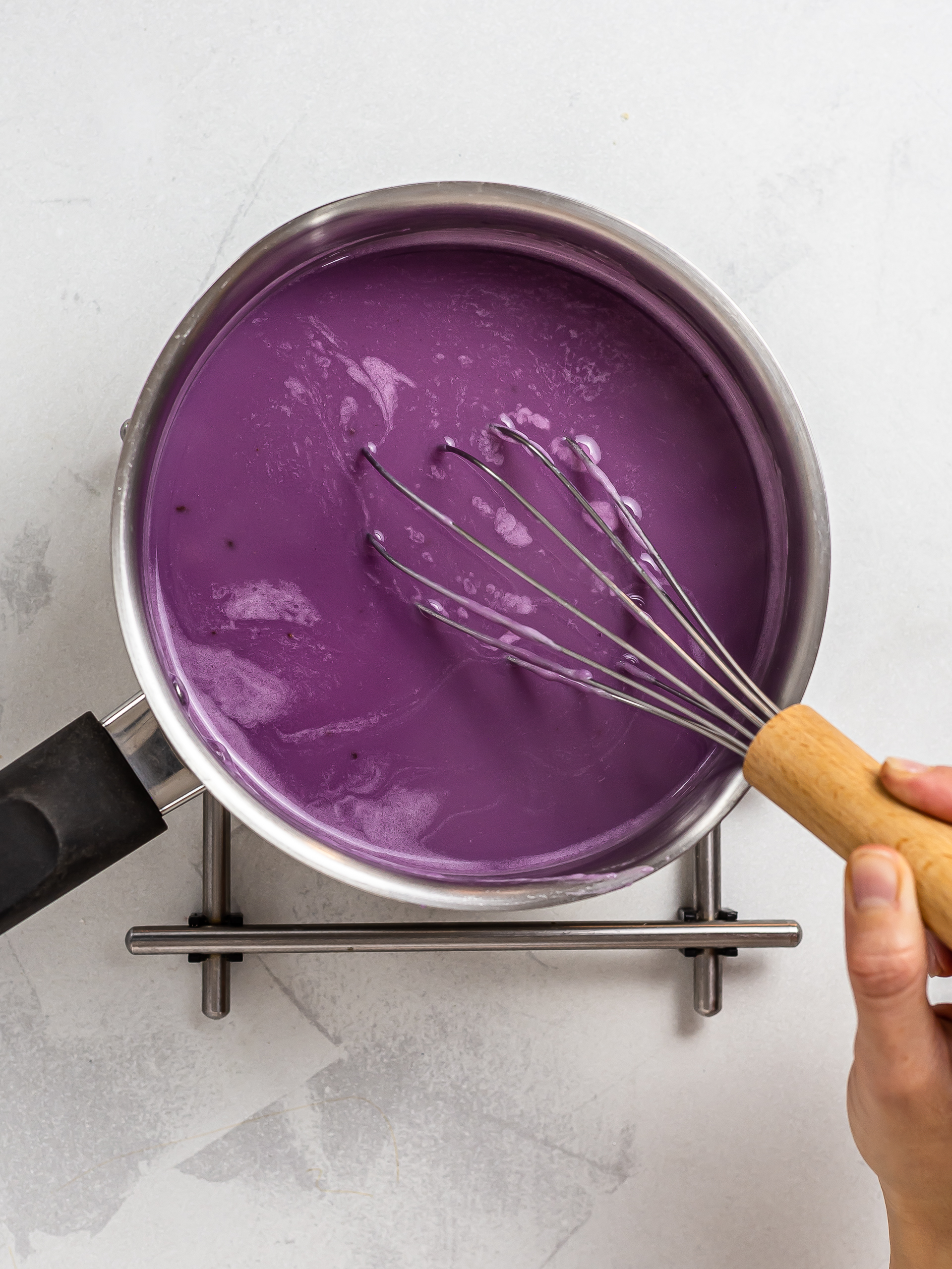 purple ube leche flan cooking in a pot