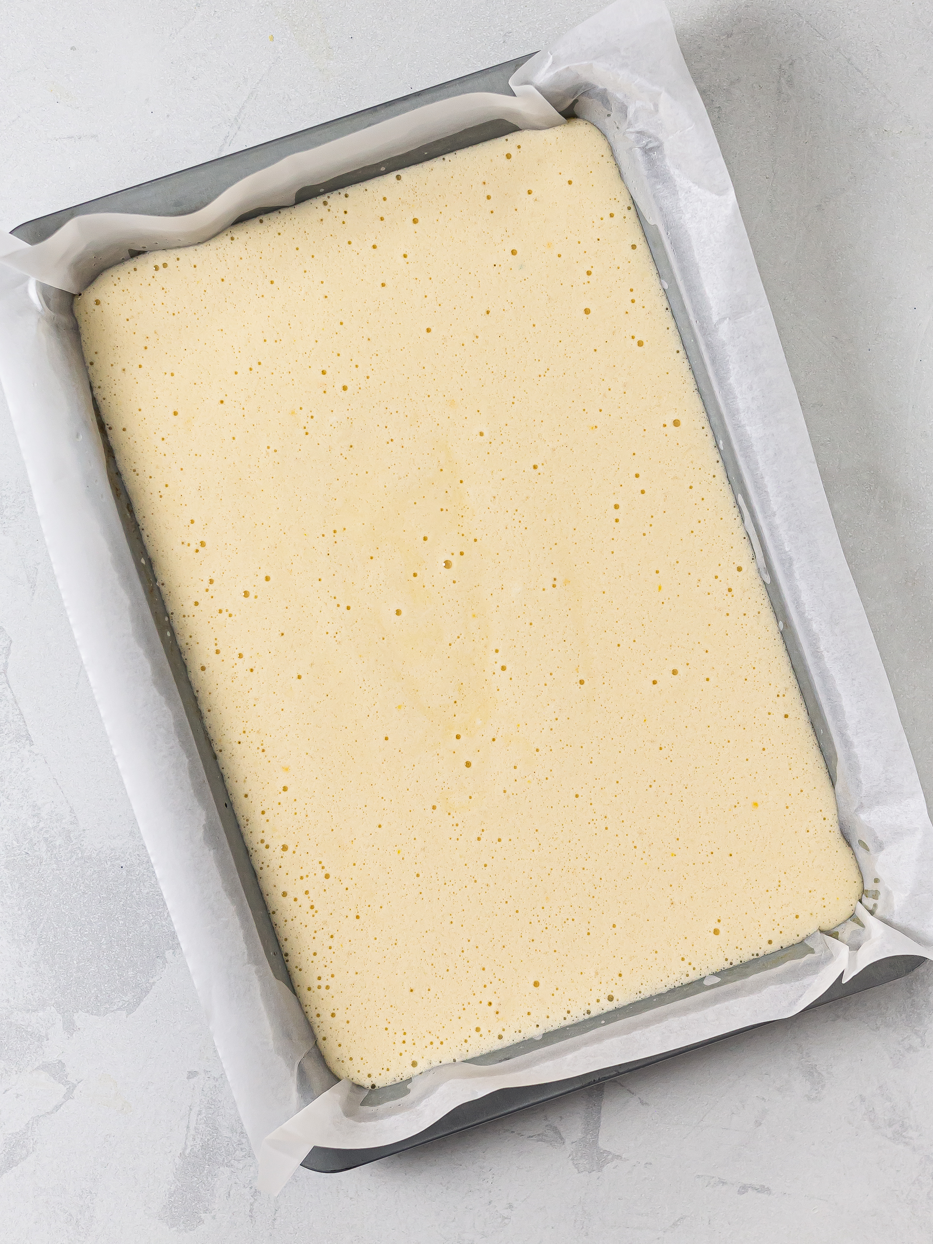 sponge cake batter in a baking tray