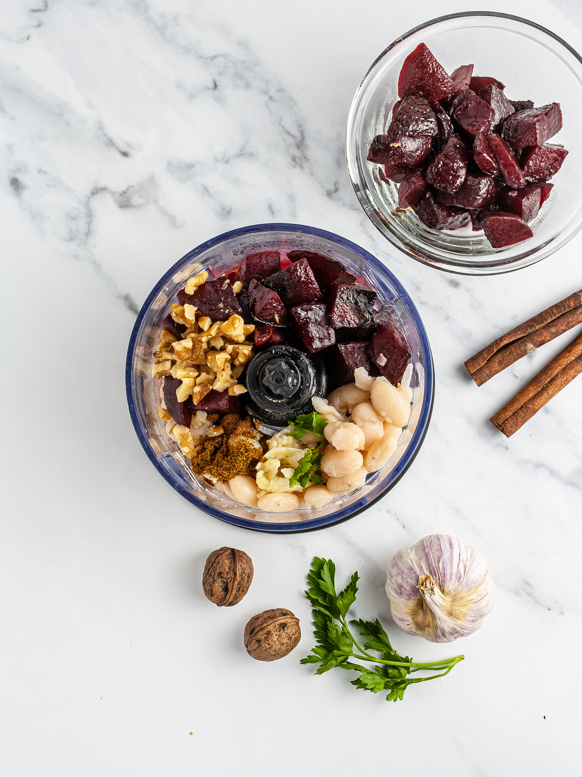 Beets, white beans, walnuts, garlic, and parsley in a blender.