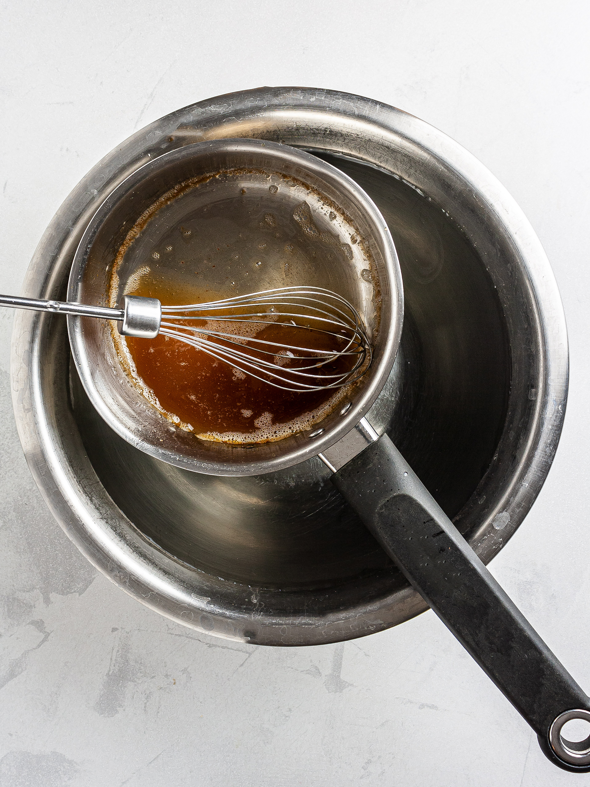 Date caramel cooling down in a water bath