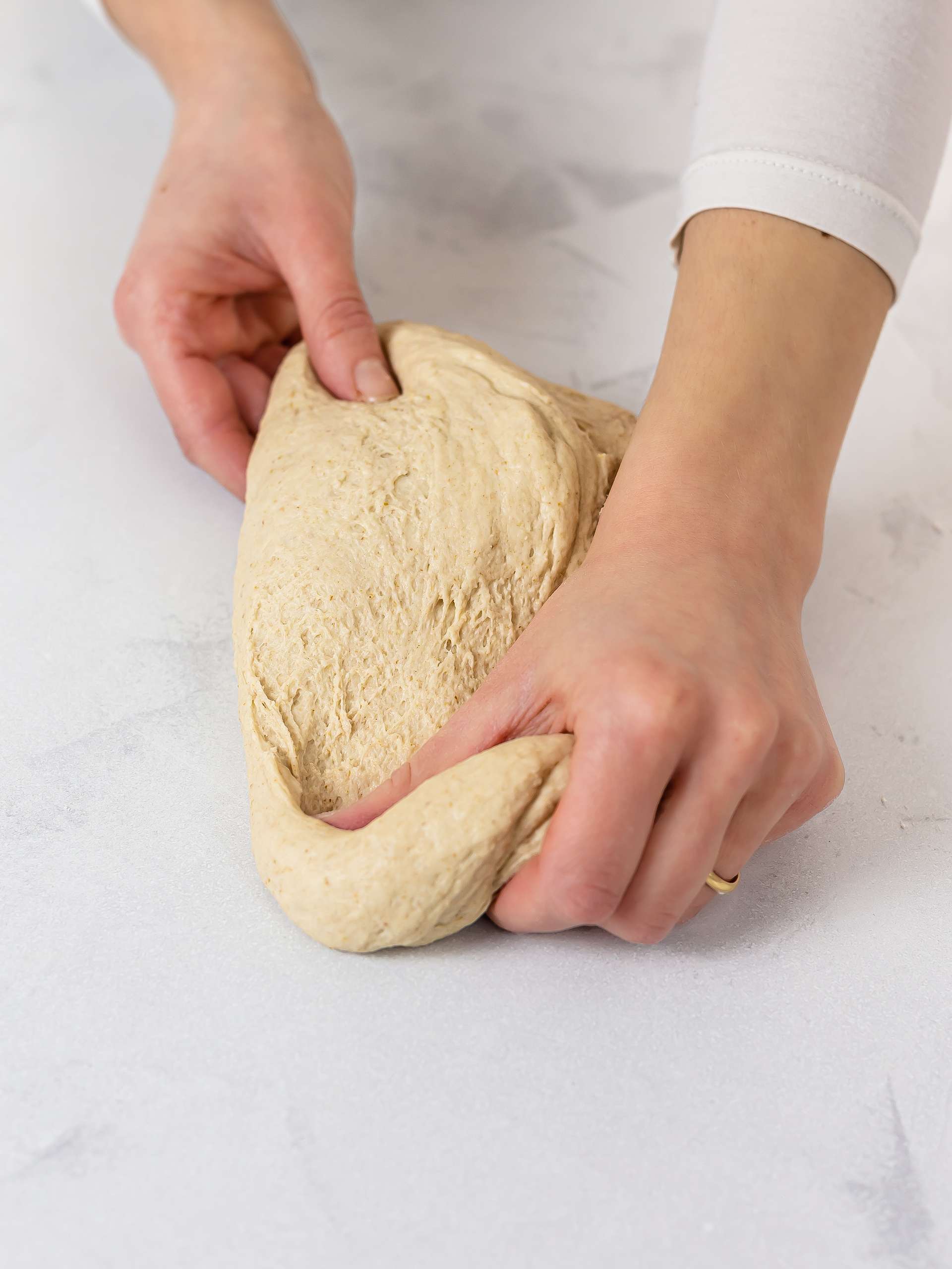 woman kneading sourdough naan dough