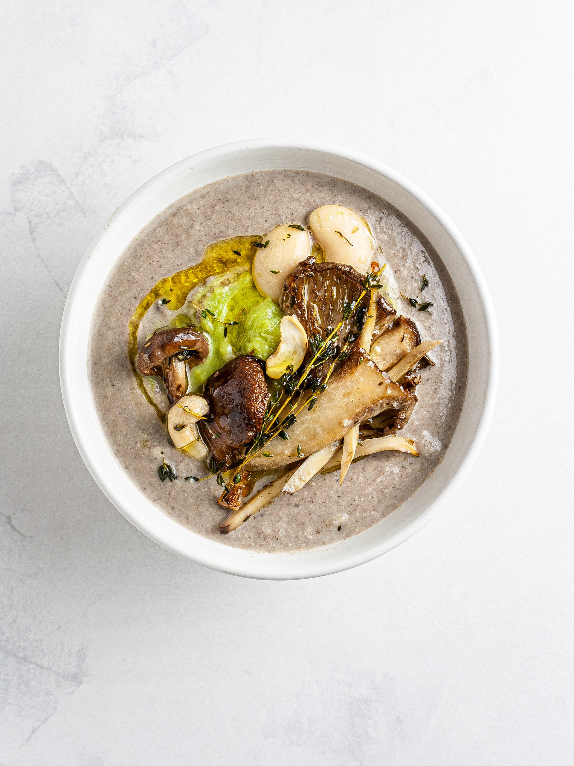 Vegan mushroom soup topped with leek purée
