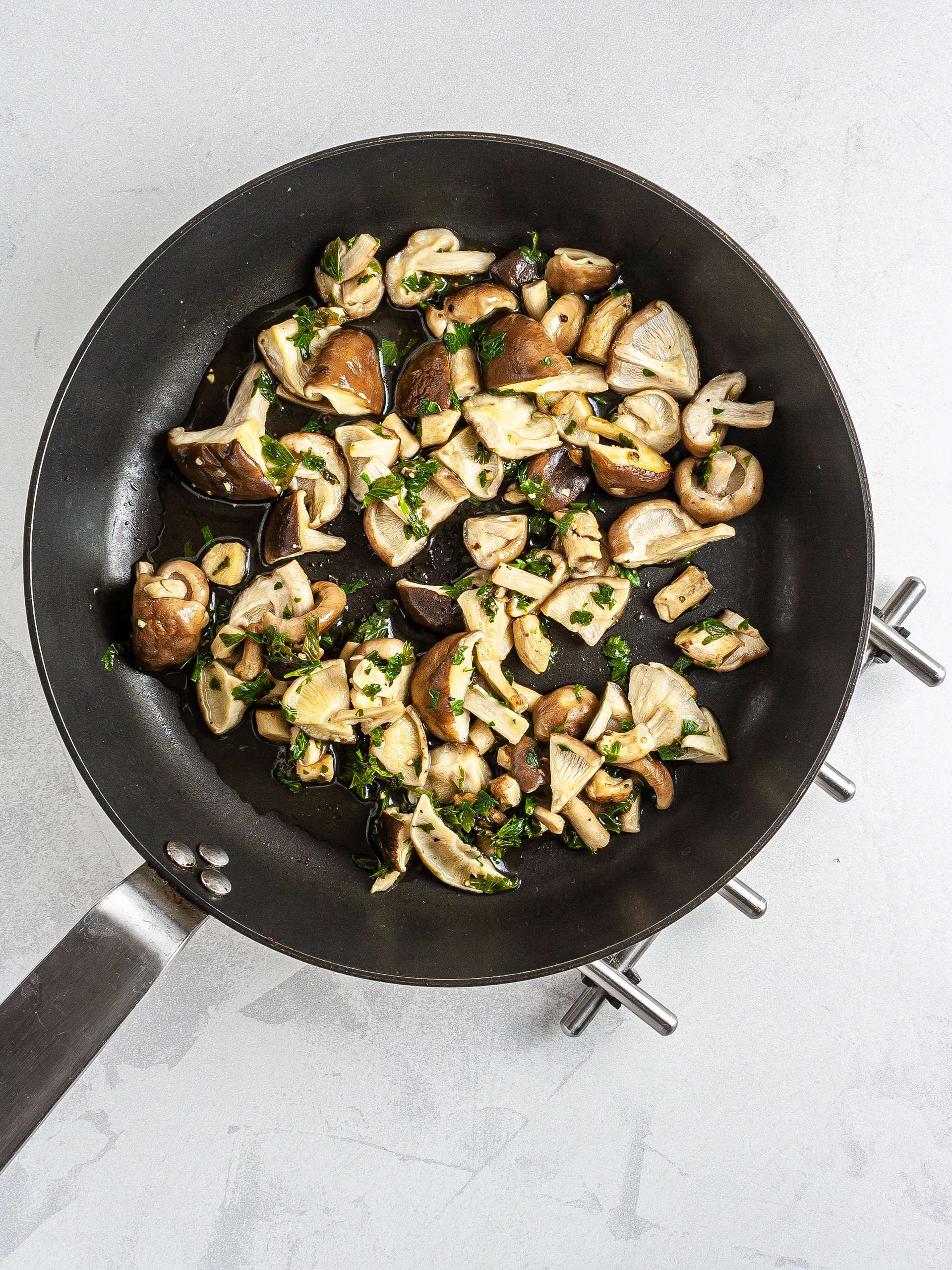 Mushrooms cooked with parsley and pepper in a skillet