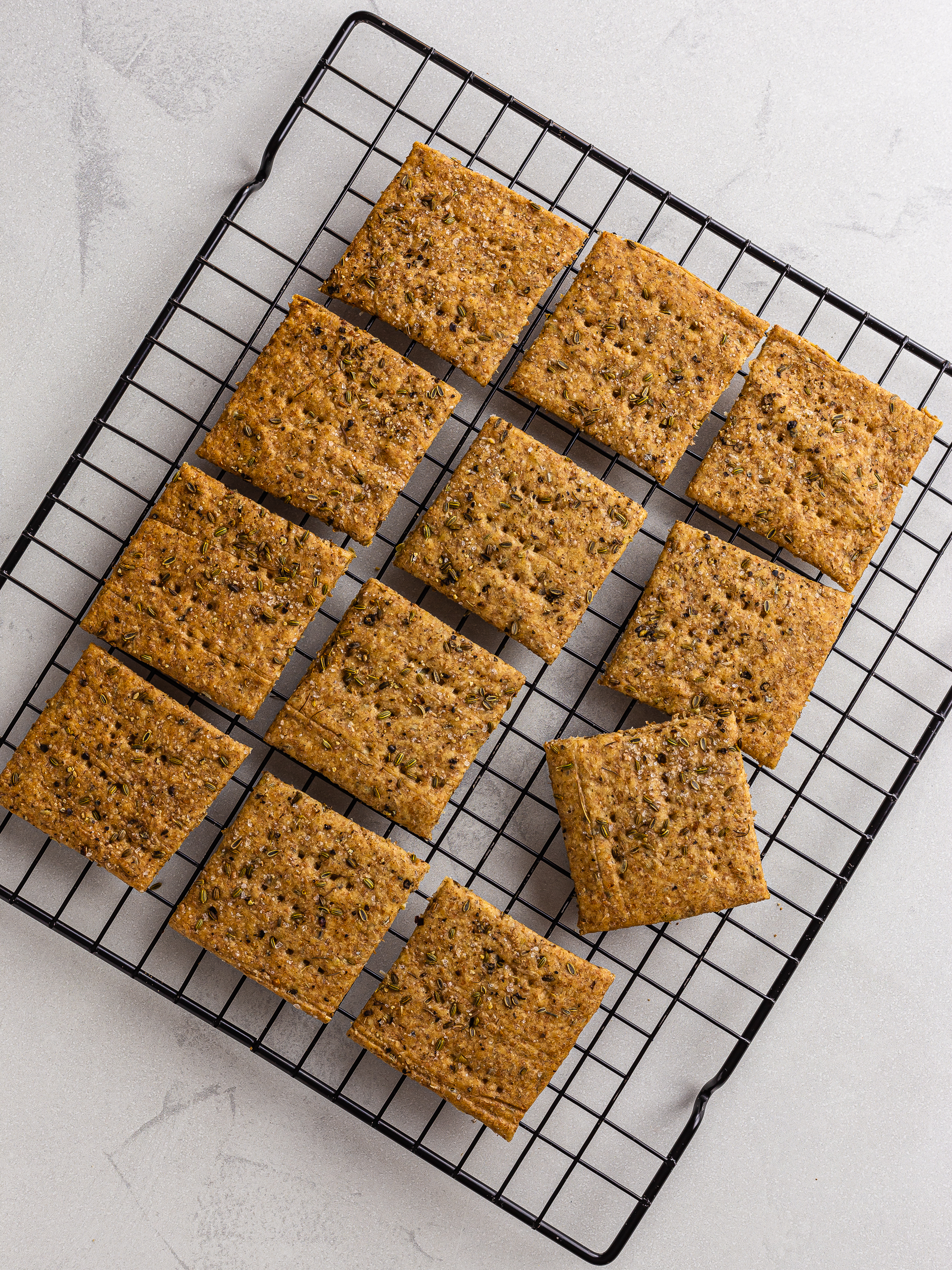 baked fennel sourdough crackers on a rack