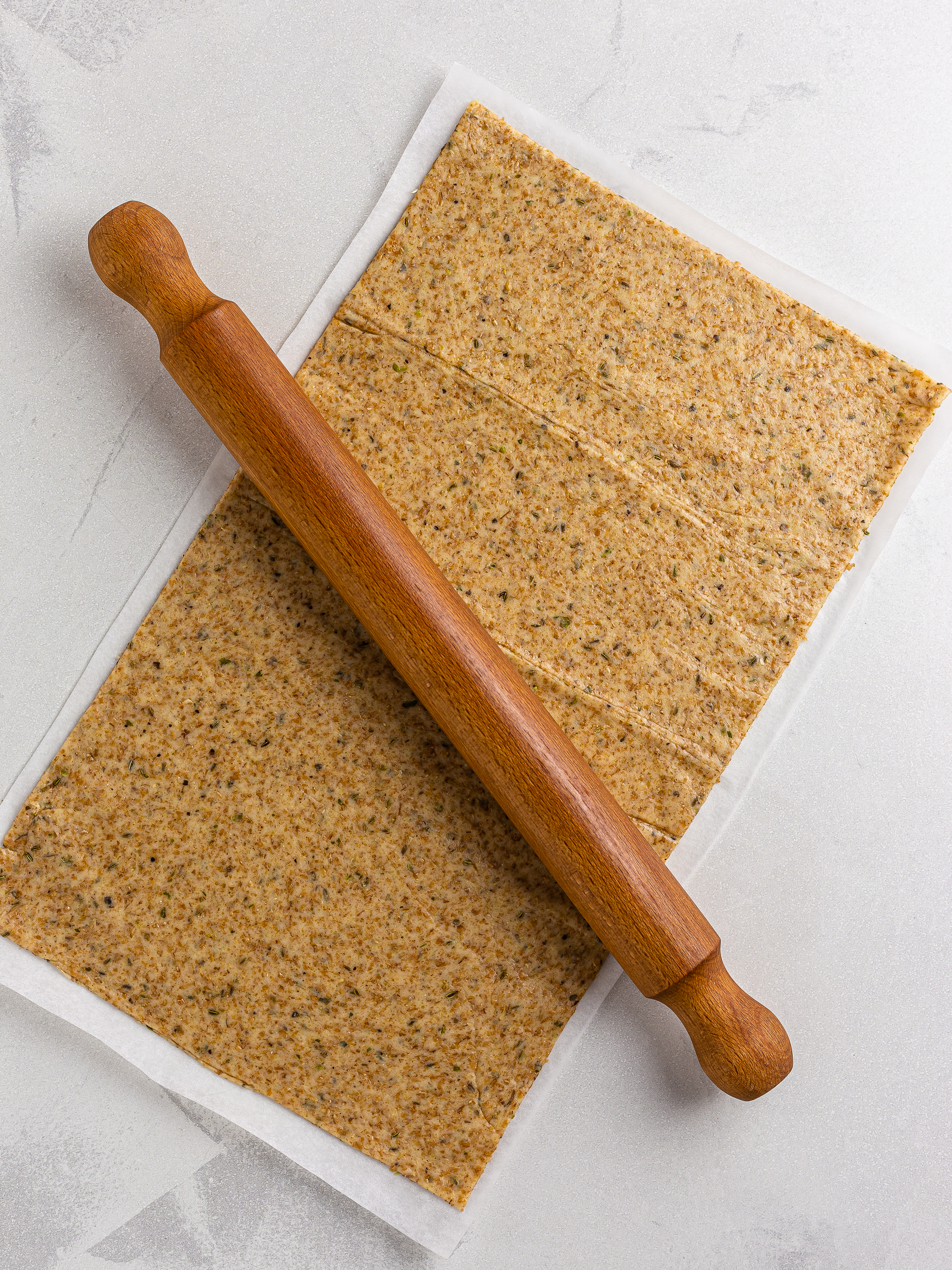 sourdough cracker dough rolled out with rolling pin