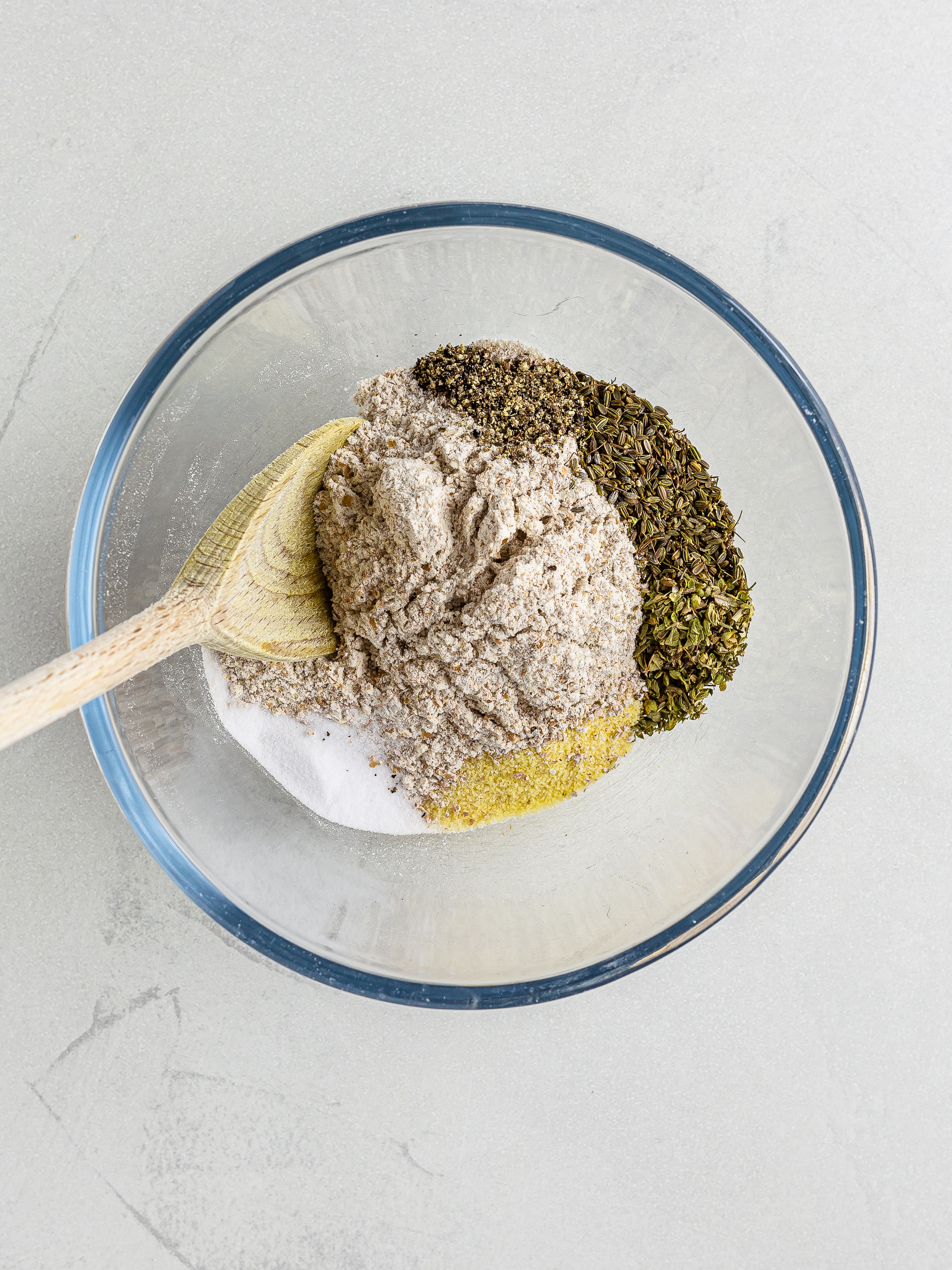 whole wheat flour, semolina and italian herbs in a bowl