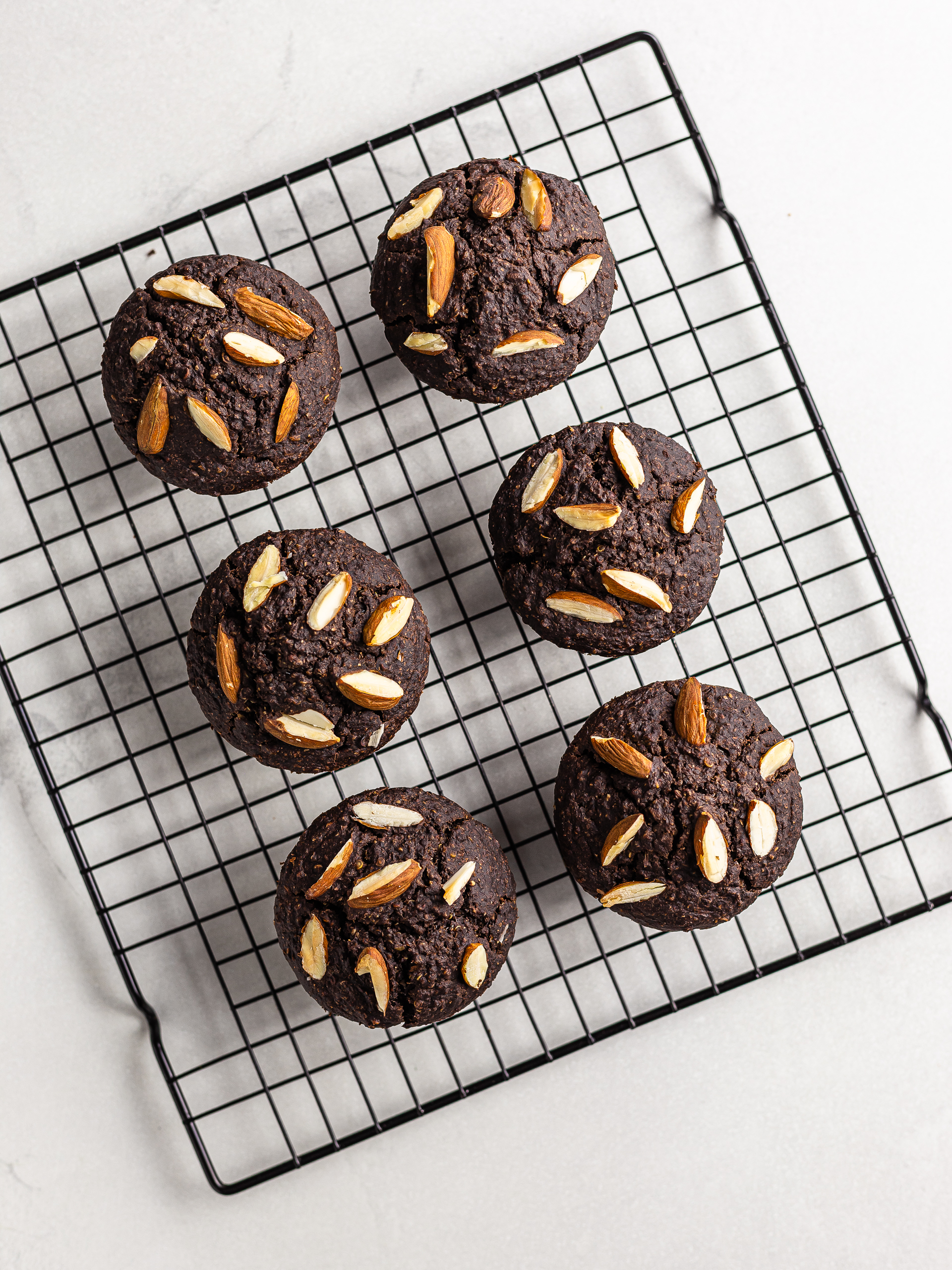 baked chocolate quinoa muffins on a rack