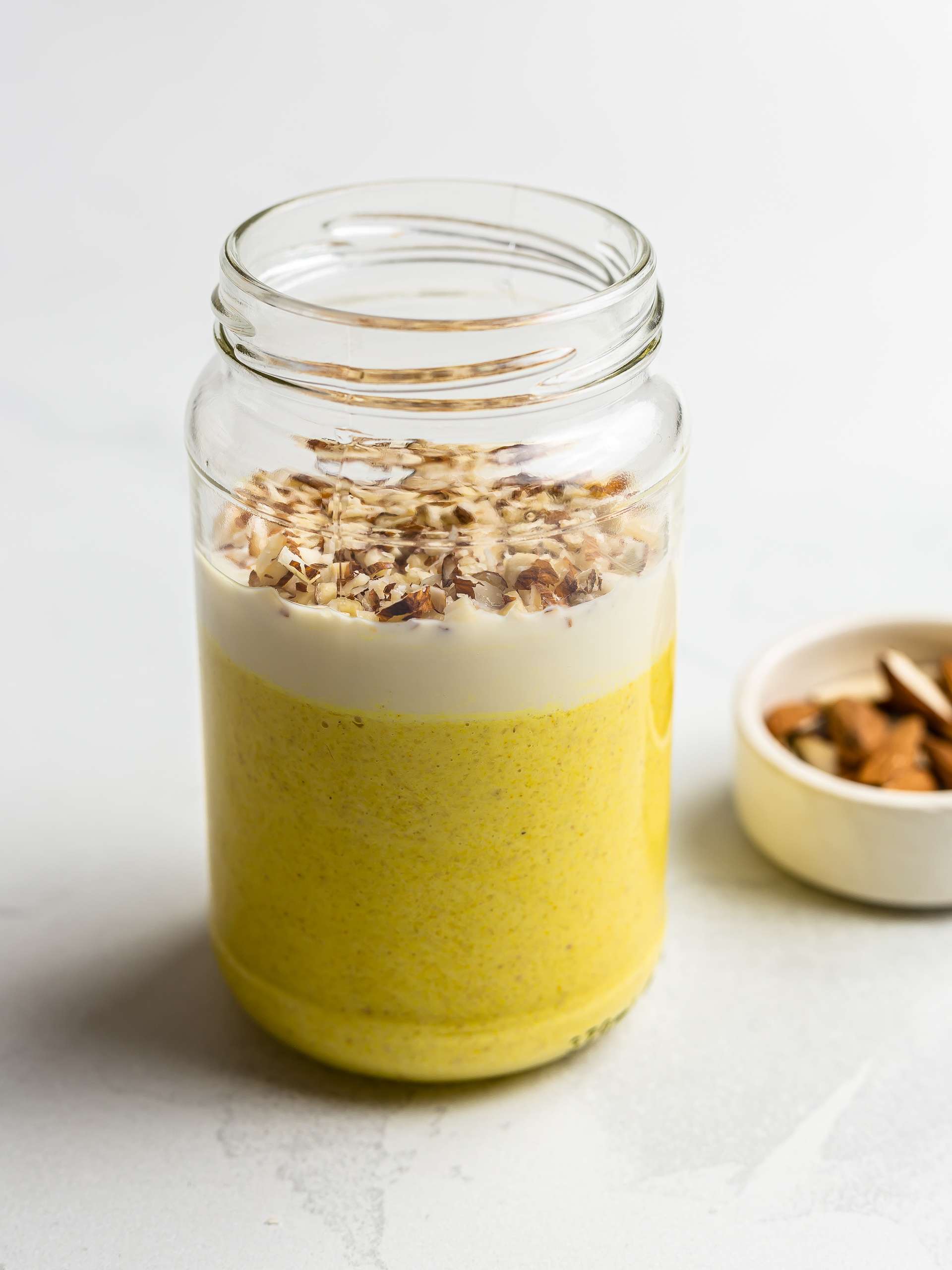 mango lassi oats in a jar with chopped almonds