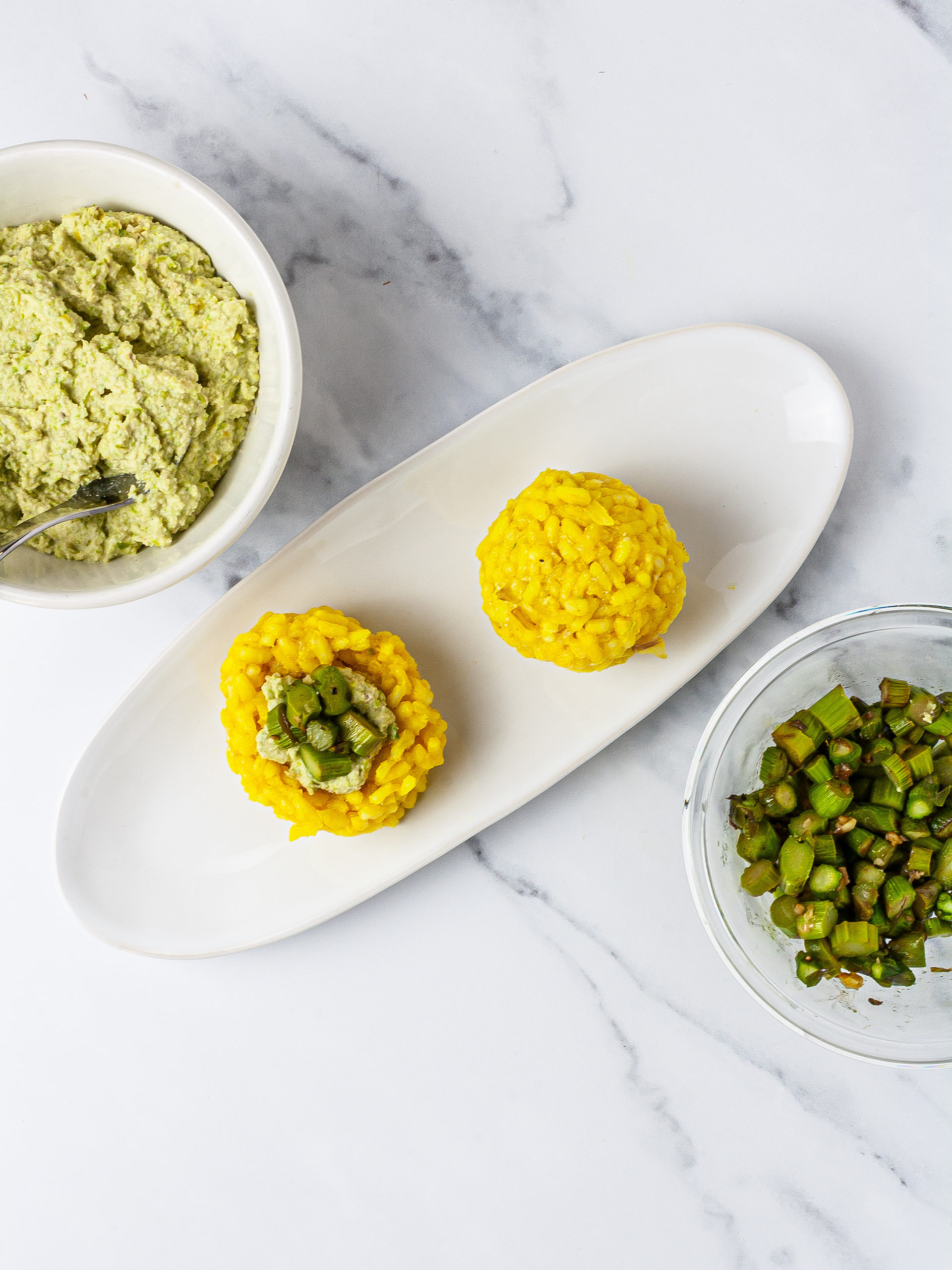 Arancini rice with asparagus and cashew nuts filling.