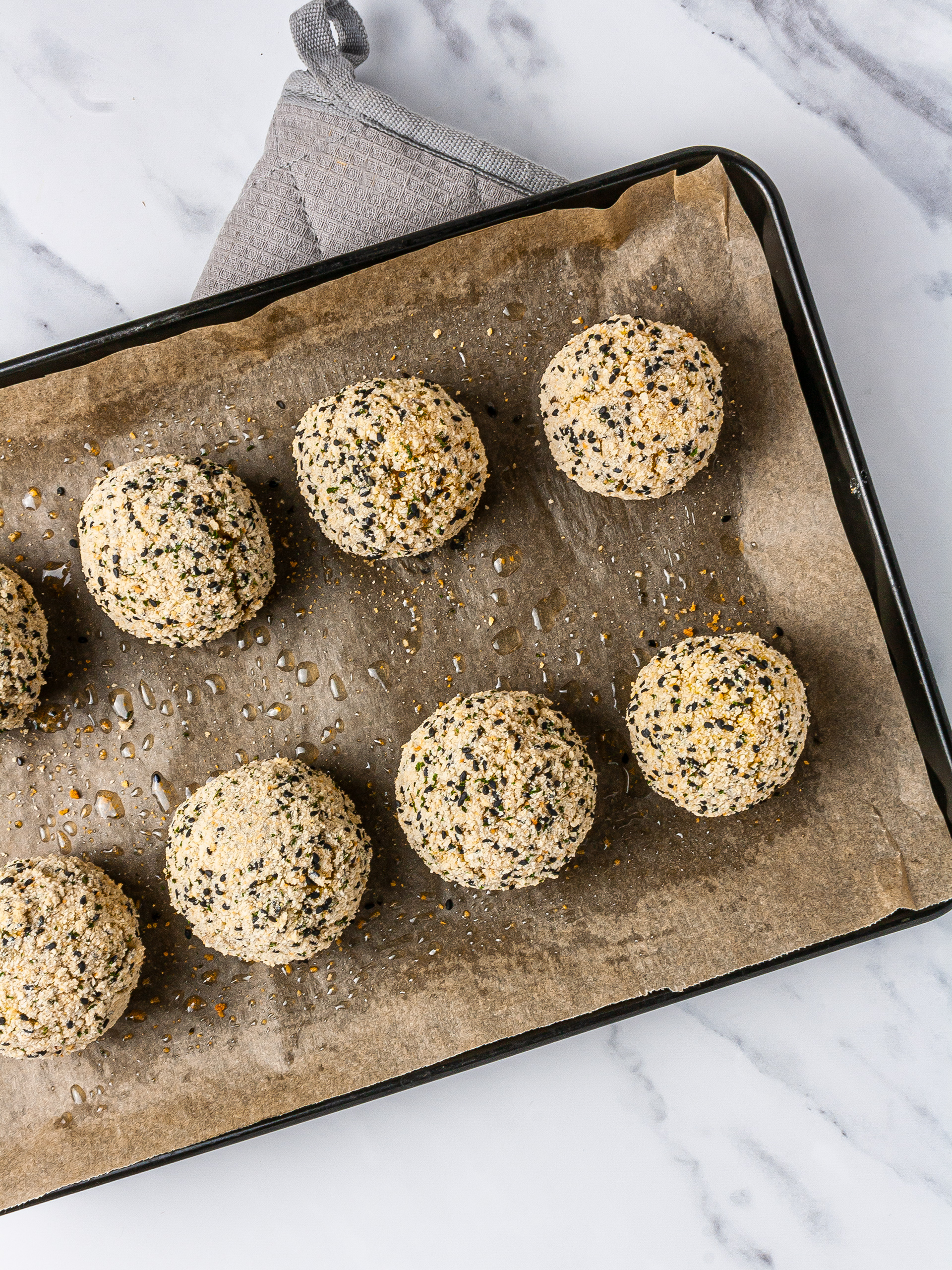 Baked arancini rice balls in a baking tray. 