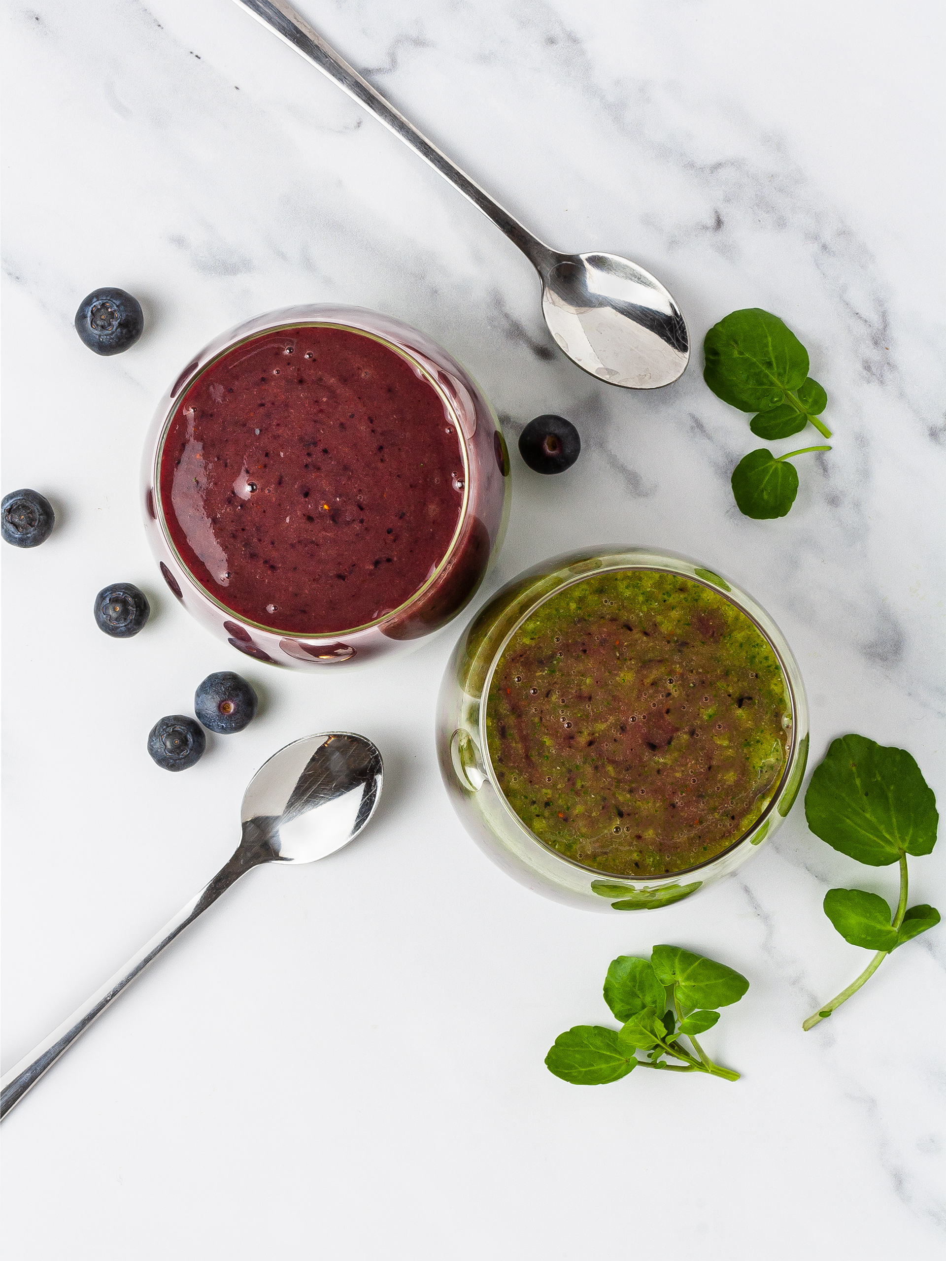Watercress and blueberry green smoothie in serving glasses.