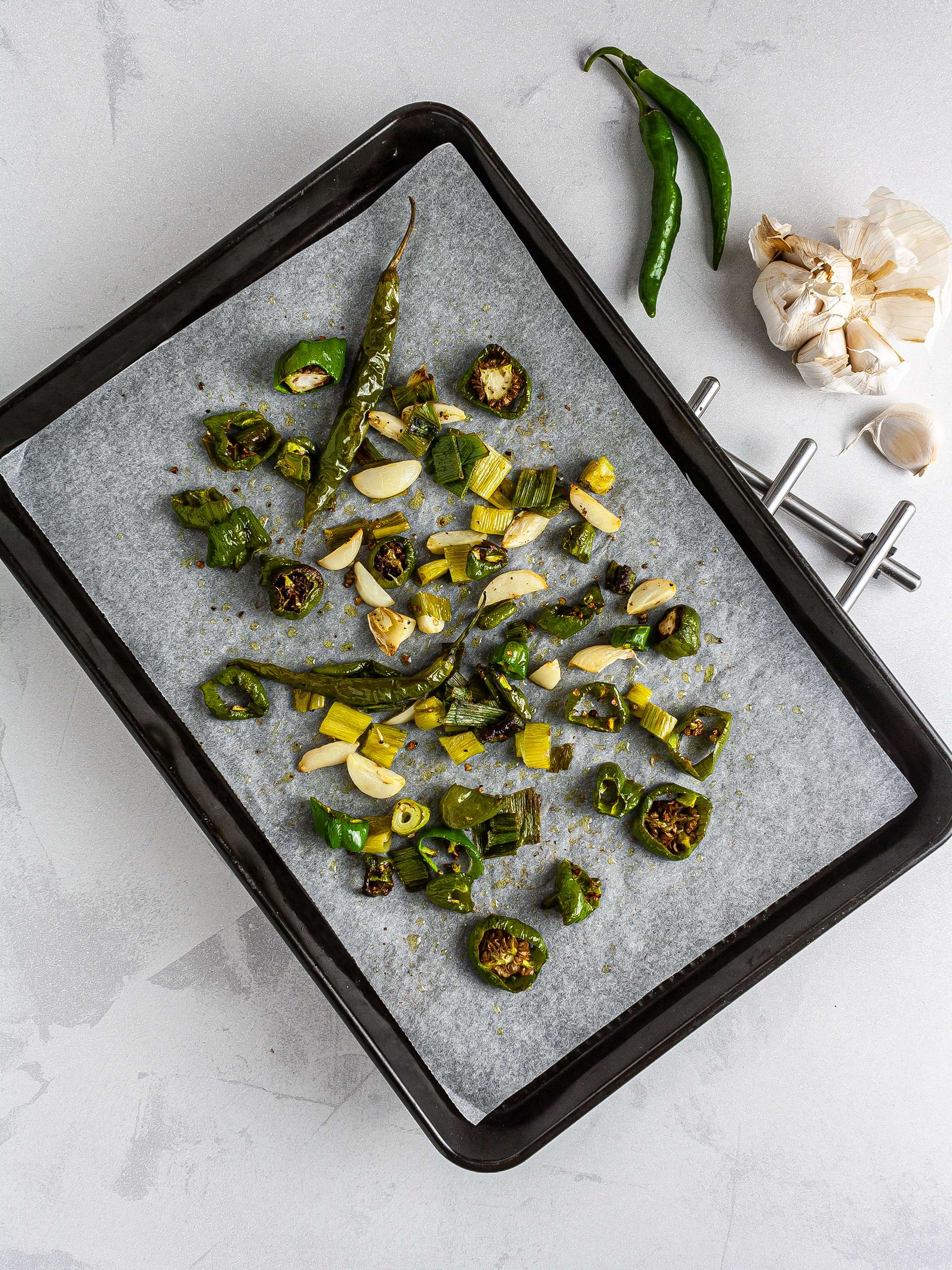 Roasted green chilli peppers with garlic and spring onions