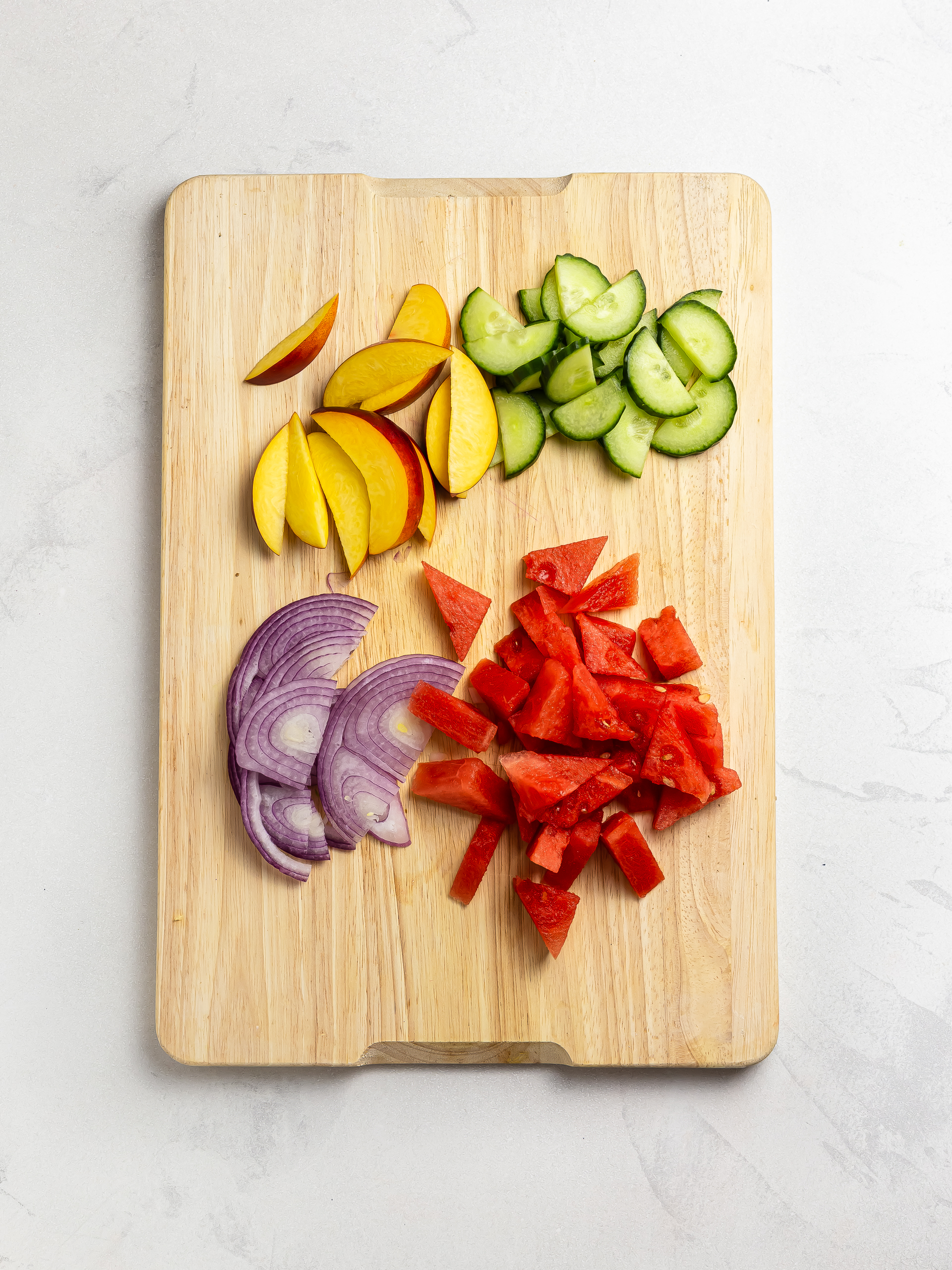 sliced watermelon peaches cucumber and onions