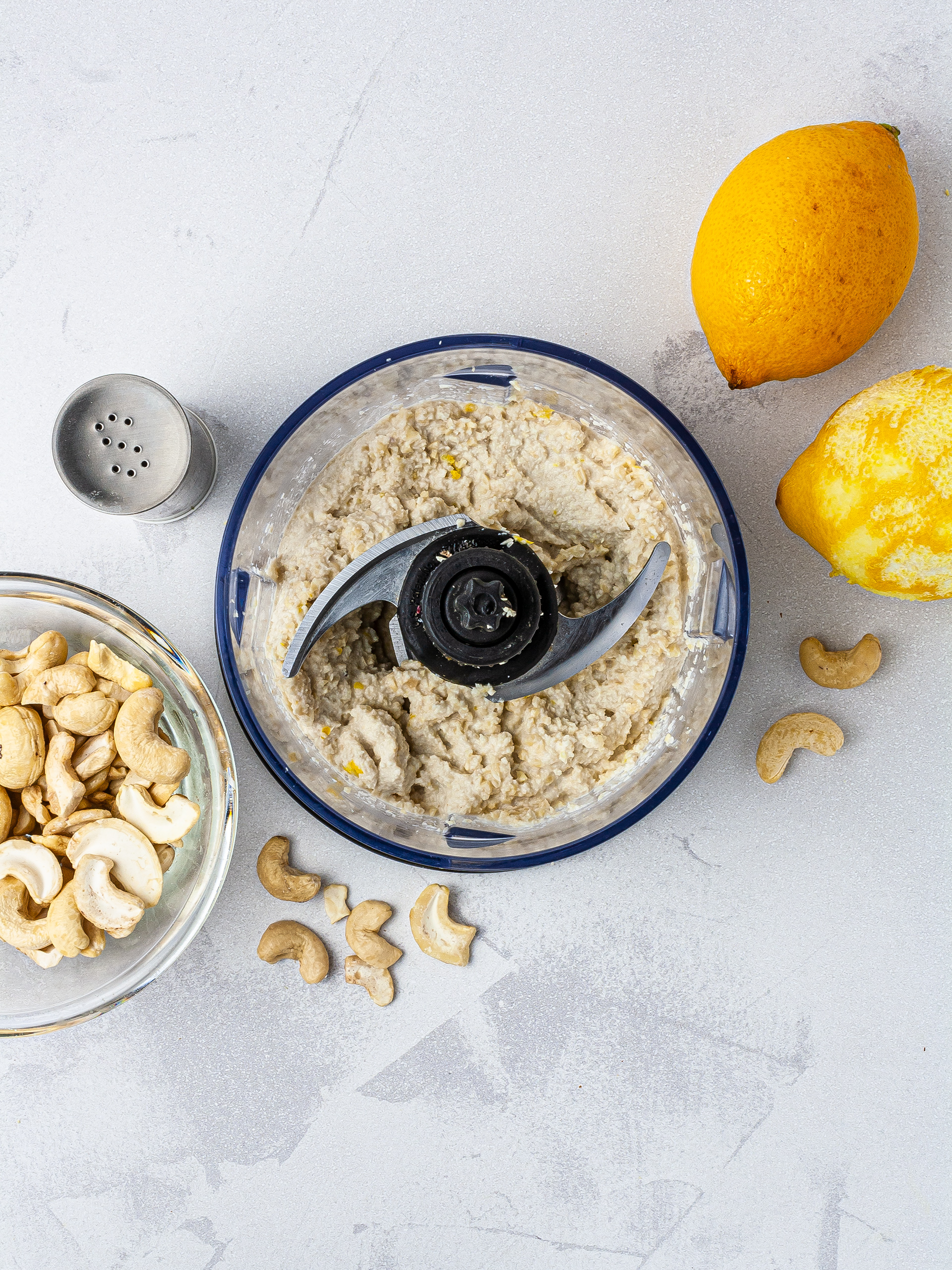 Vegan cream cheese made with soaked cashew nuts, lemon zest, and salt blended in a food processor.