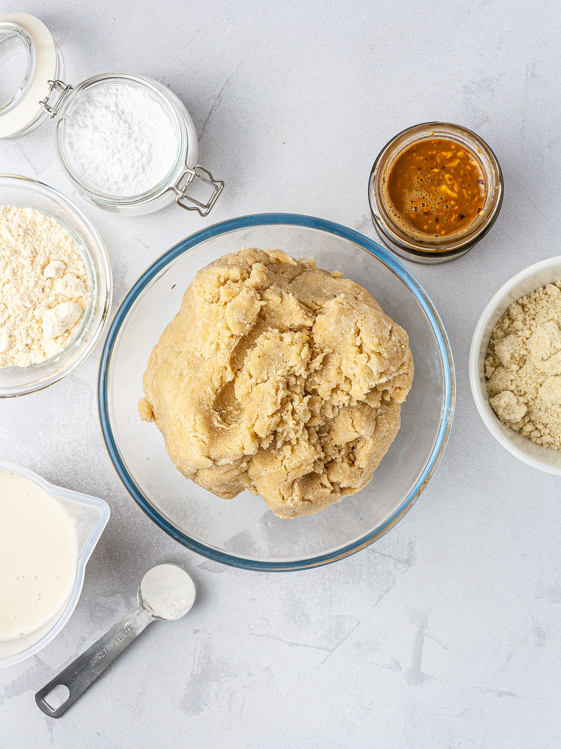 Almond cookie dough made with coconut flour, almond flour, almond butter, baking powder, cream cheese, and almond milk.