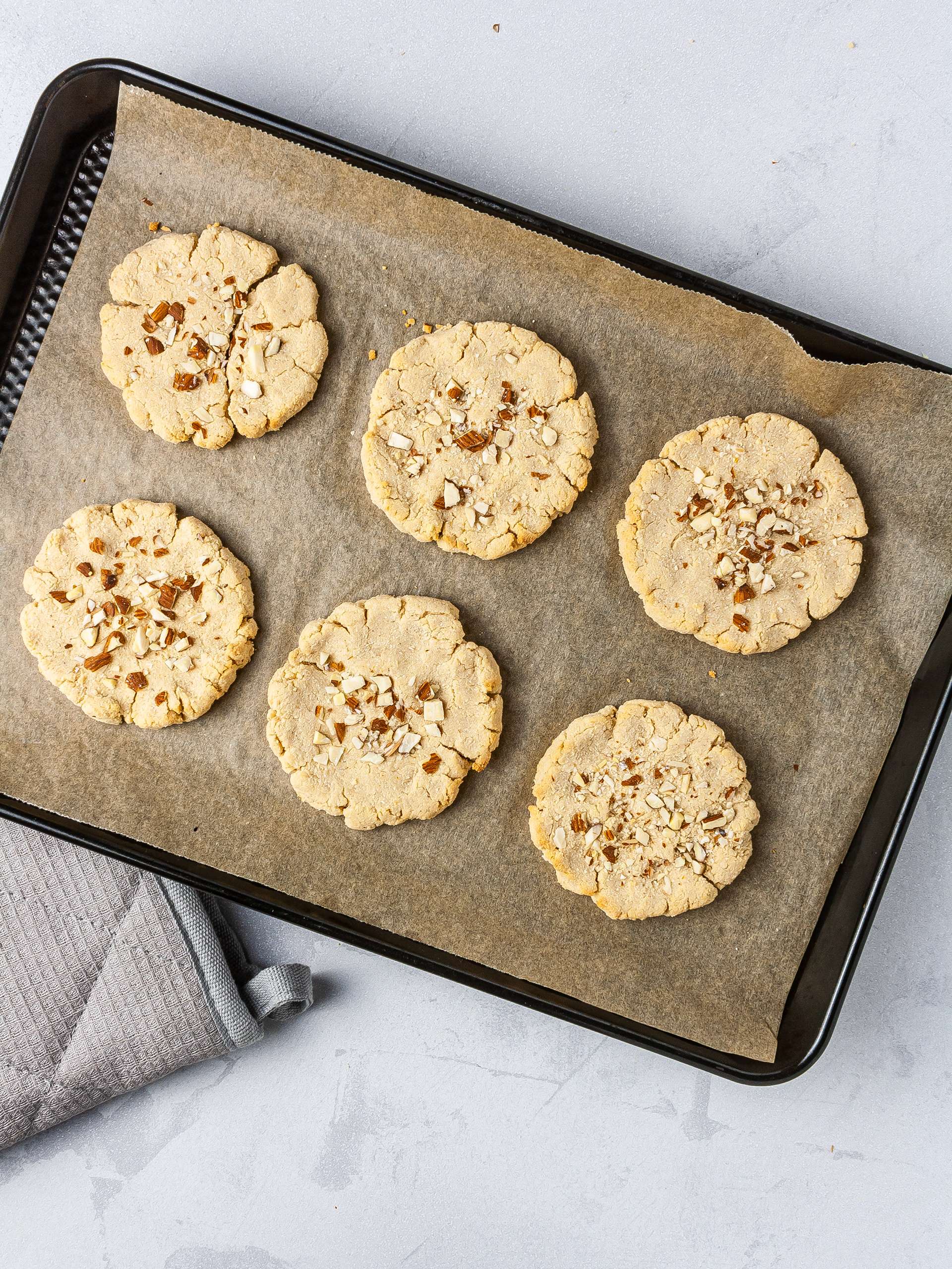 Baked almond cream cheese cookies on a baking tray.