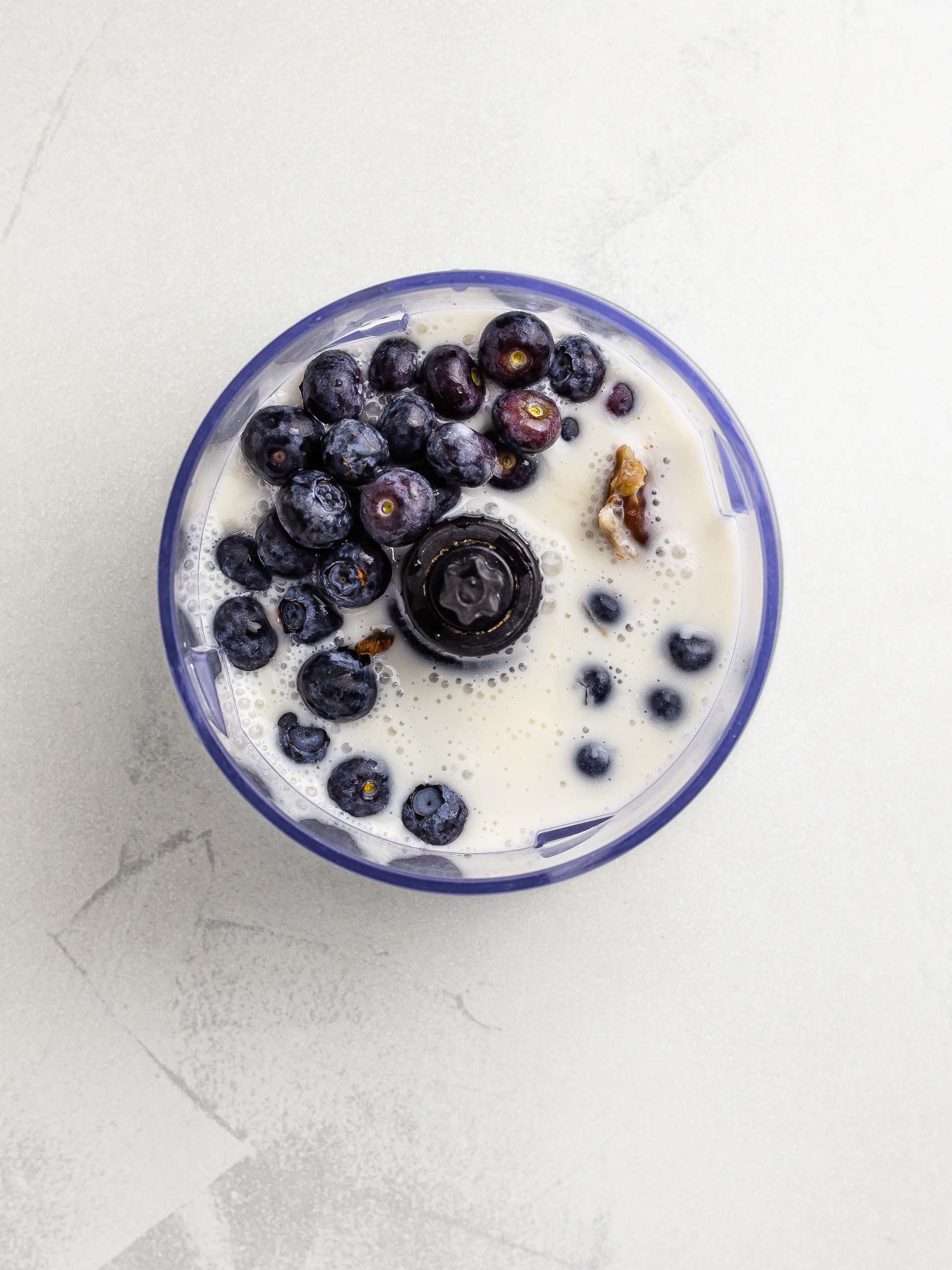 blueberries, almond milk and yogurt in a blender