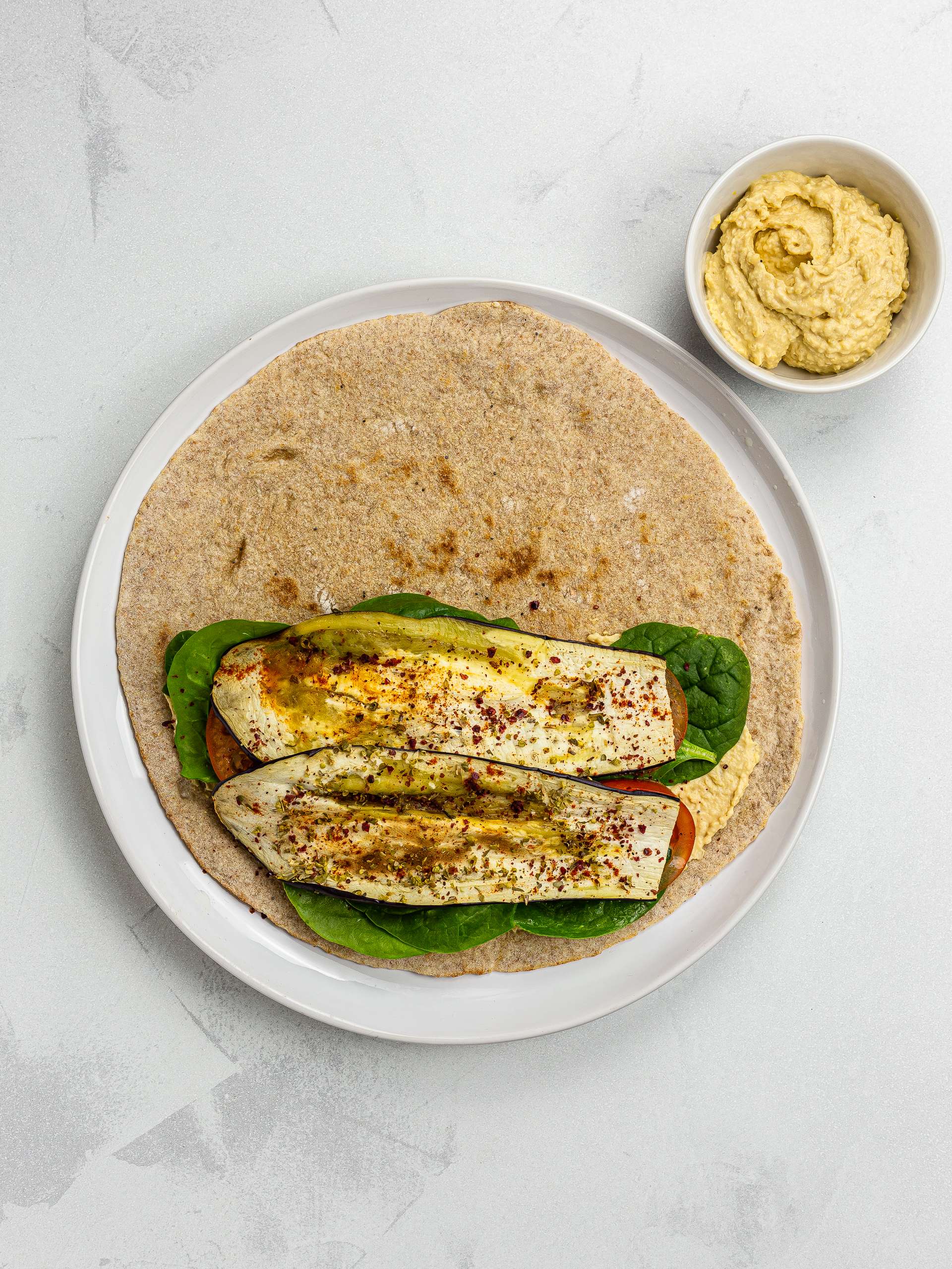 lavash bread wrap with hummus and grilled aubergines
