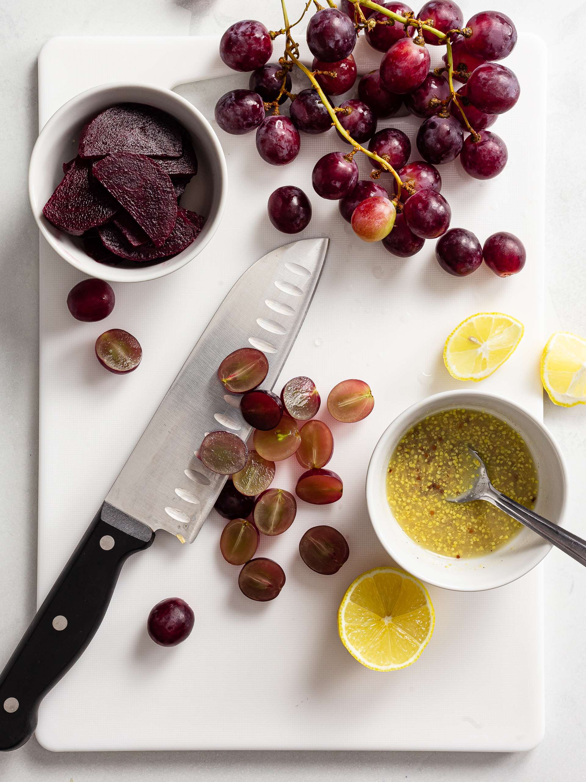 halved grapes sliced beets and mustard lemon dressing in a cup