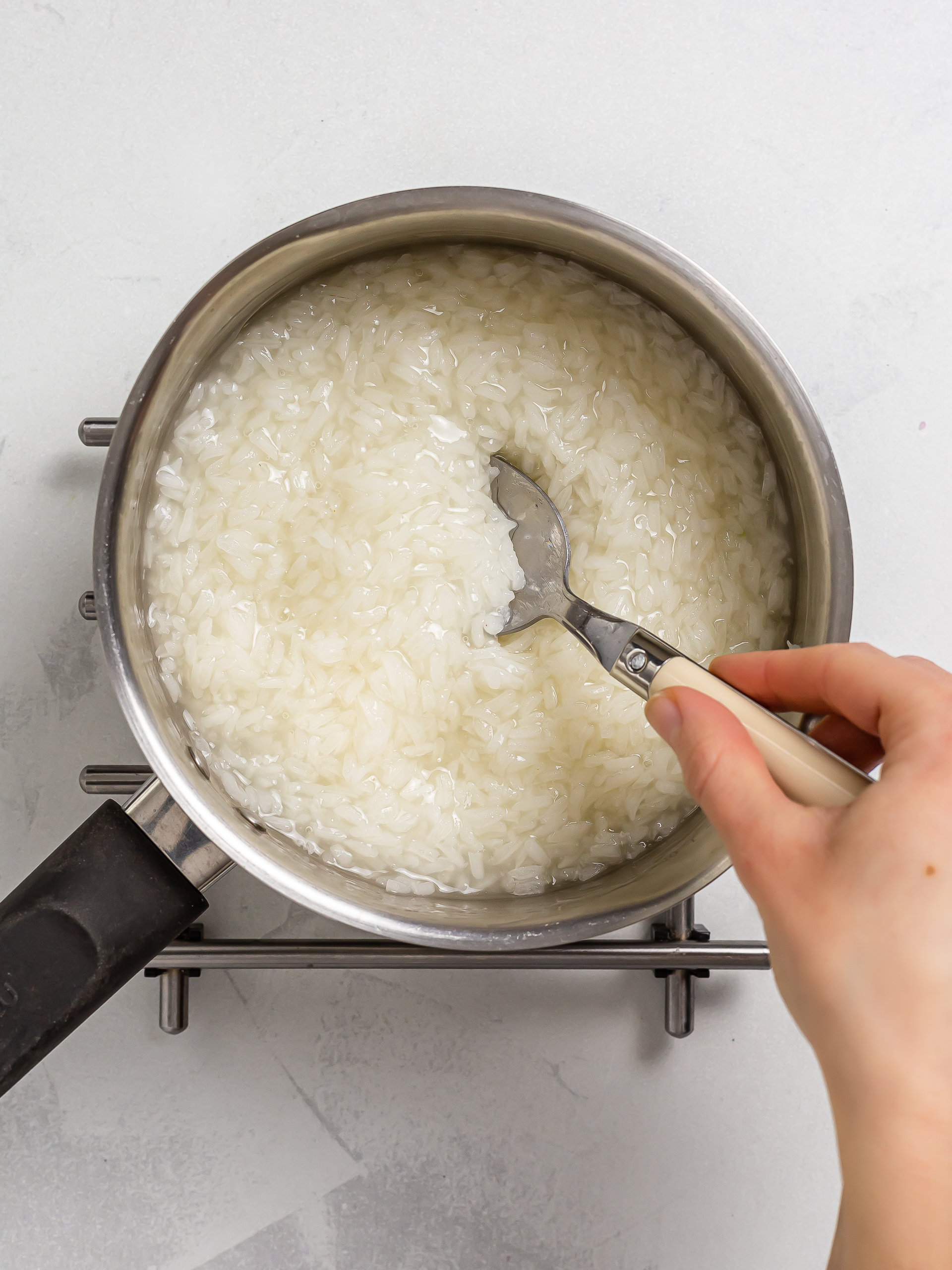 glutinous rice cooking in a pot with water