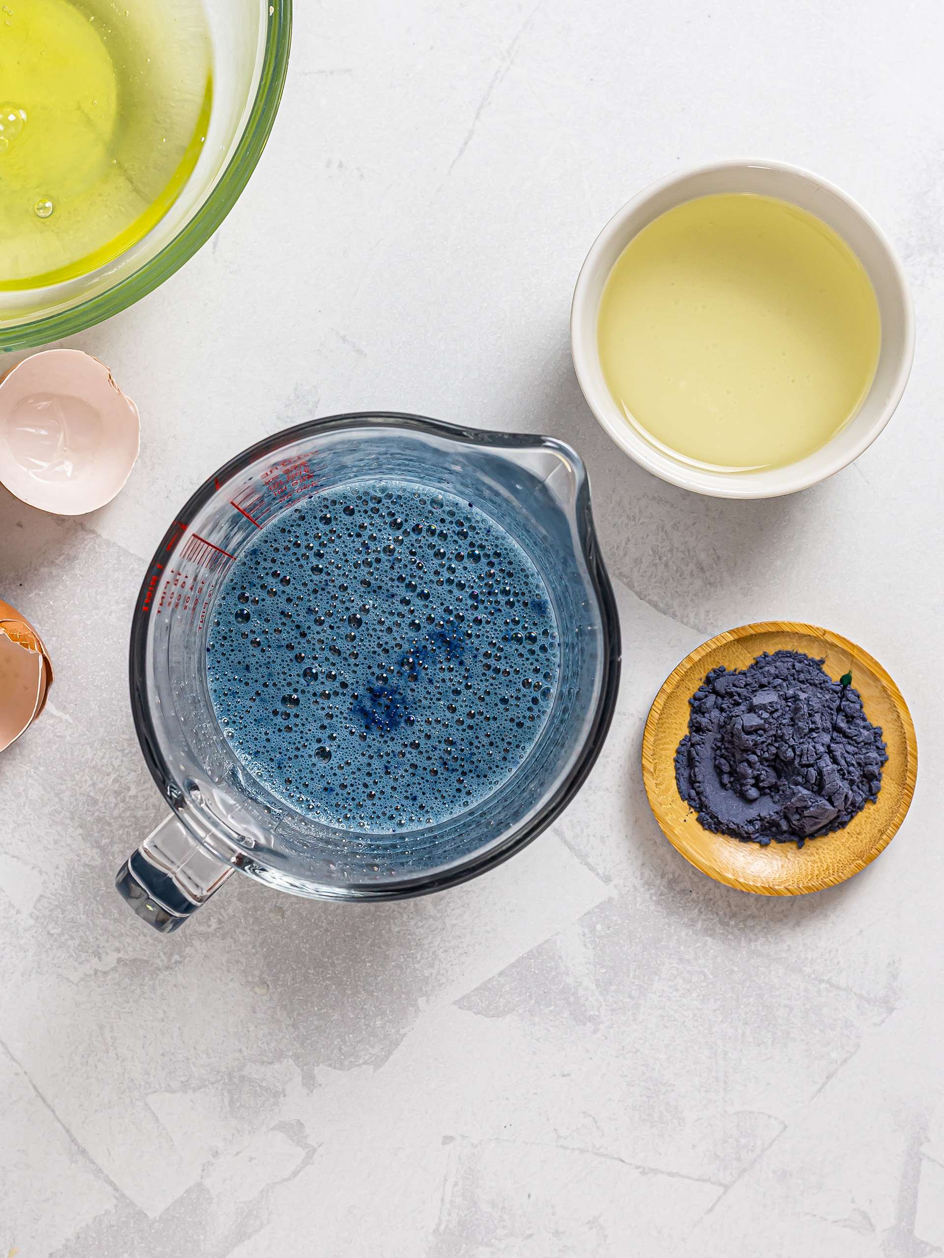 milk and eggs mixed with butterfly pea powder