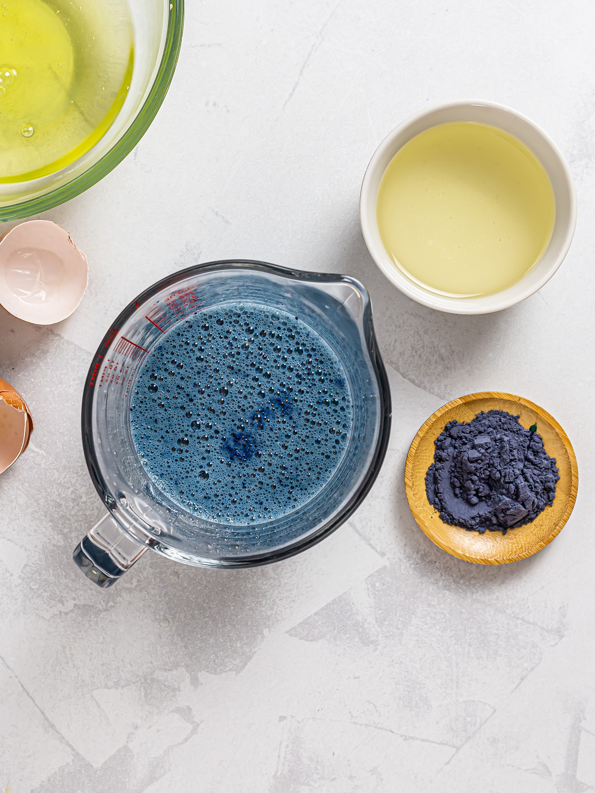 milk and eggs mixed with butterfly pea powder