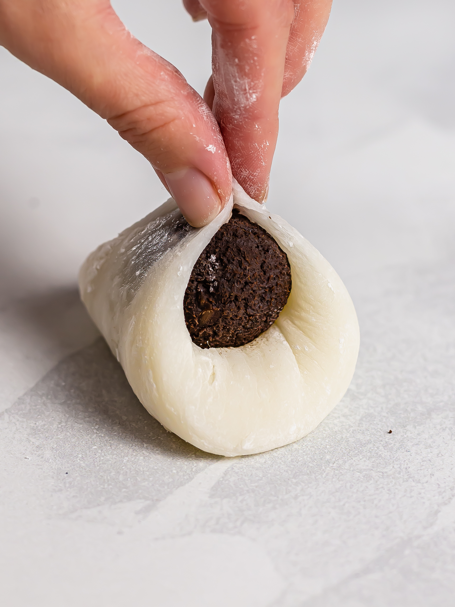 sealing mochi dough around filling