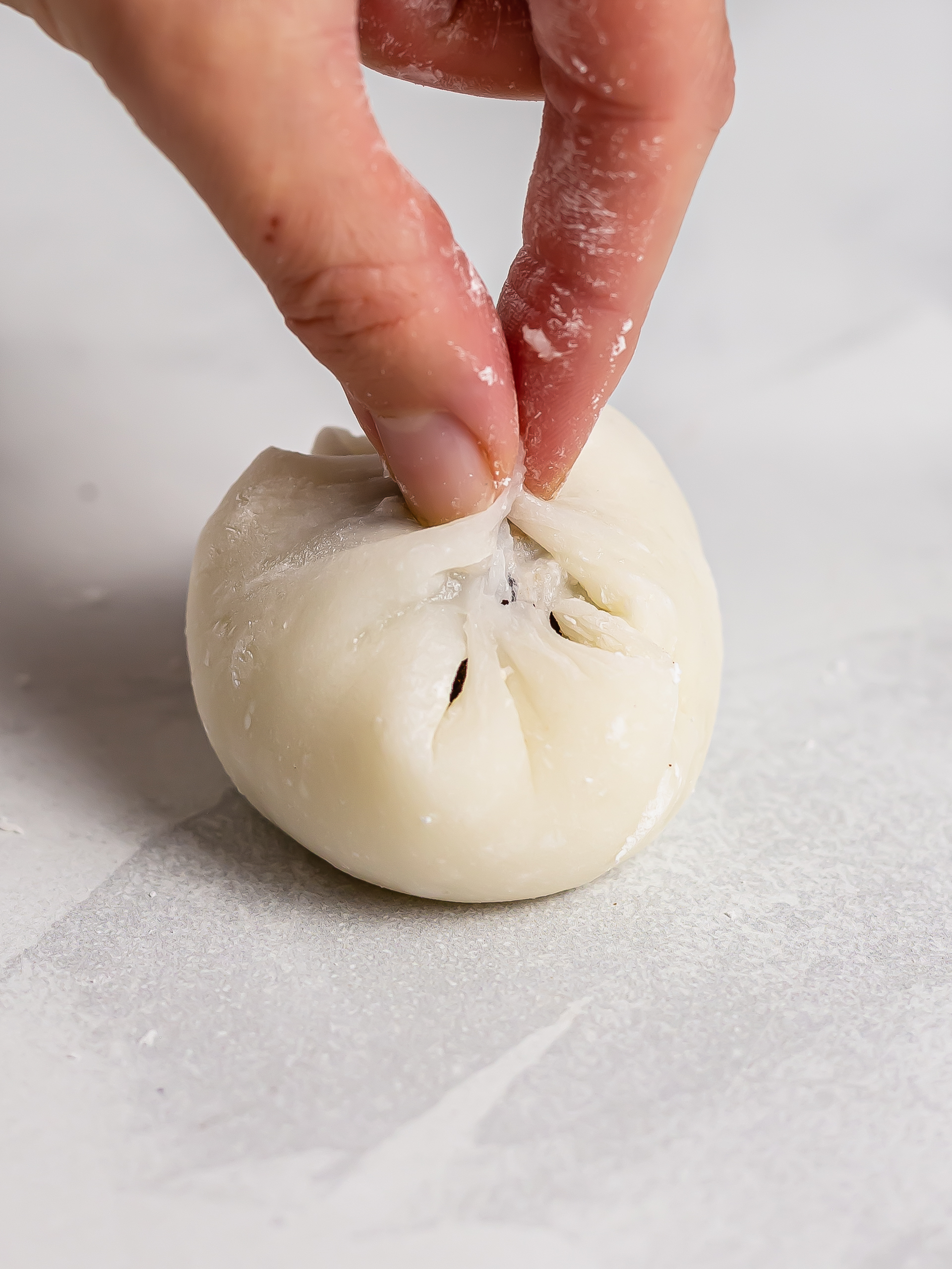 sealing mochi dough around filling