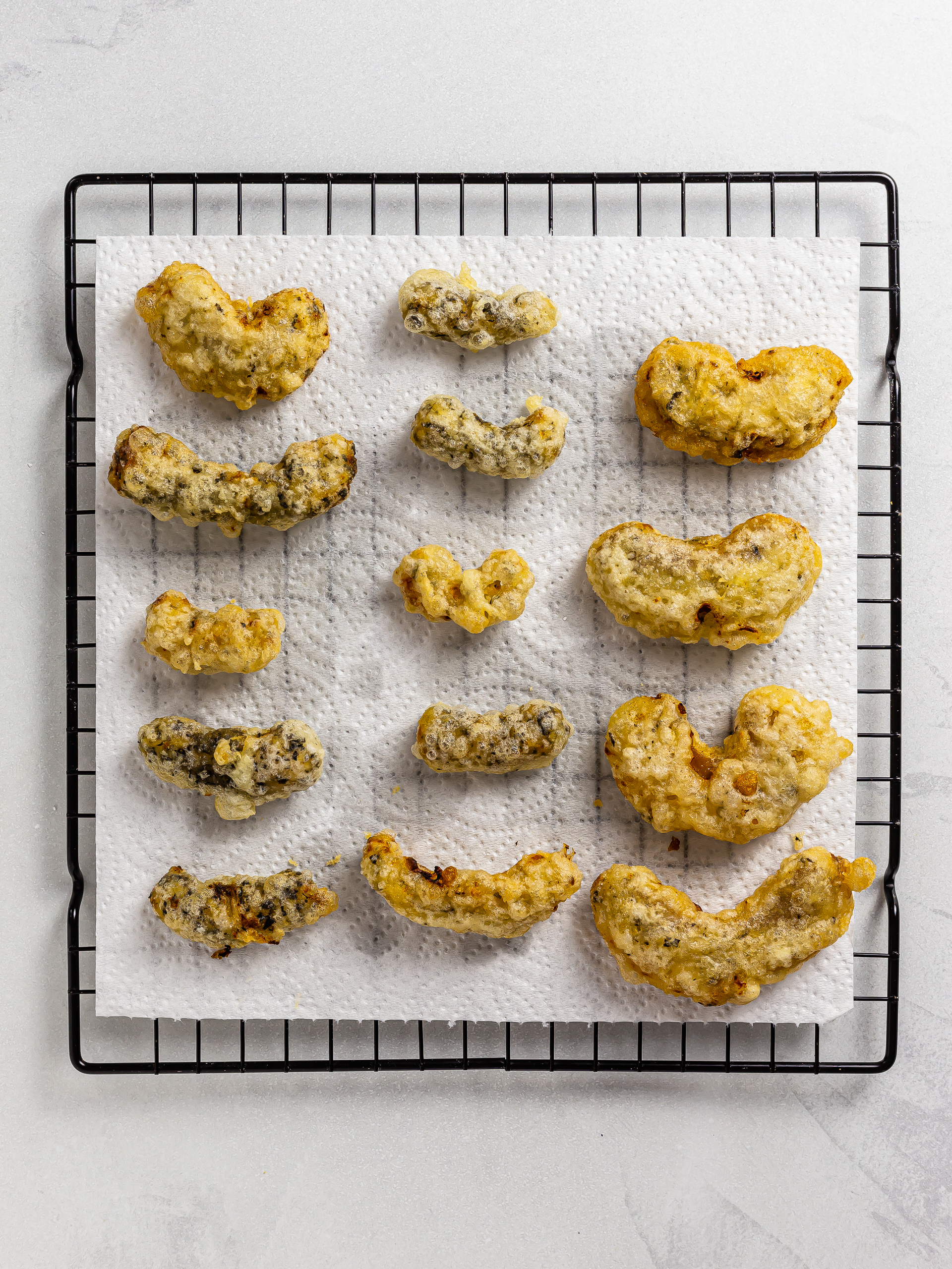 fried vegan ebi tempura draining oil on kitchen paper