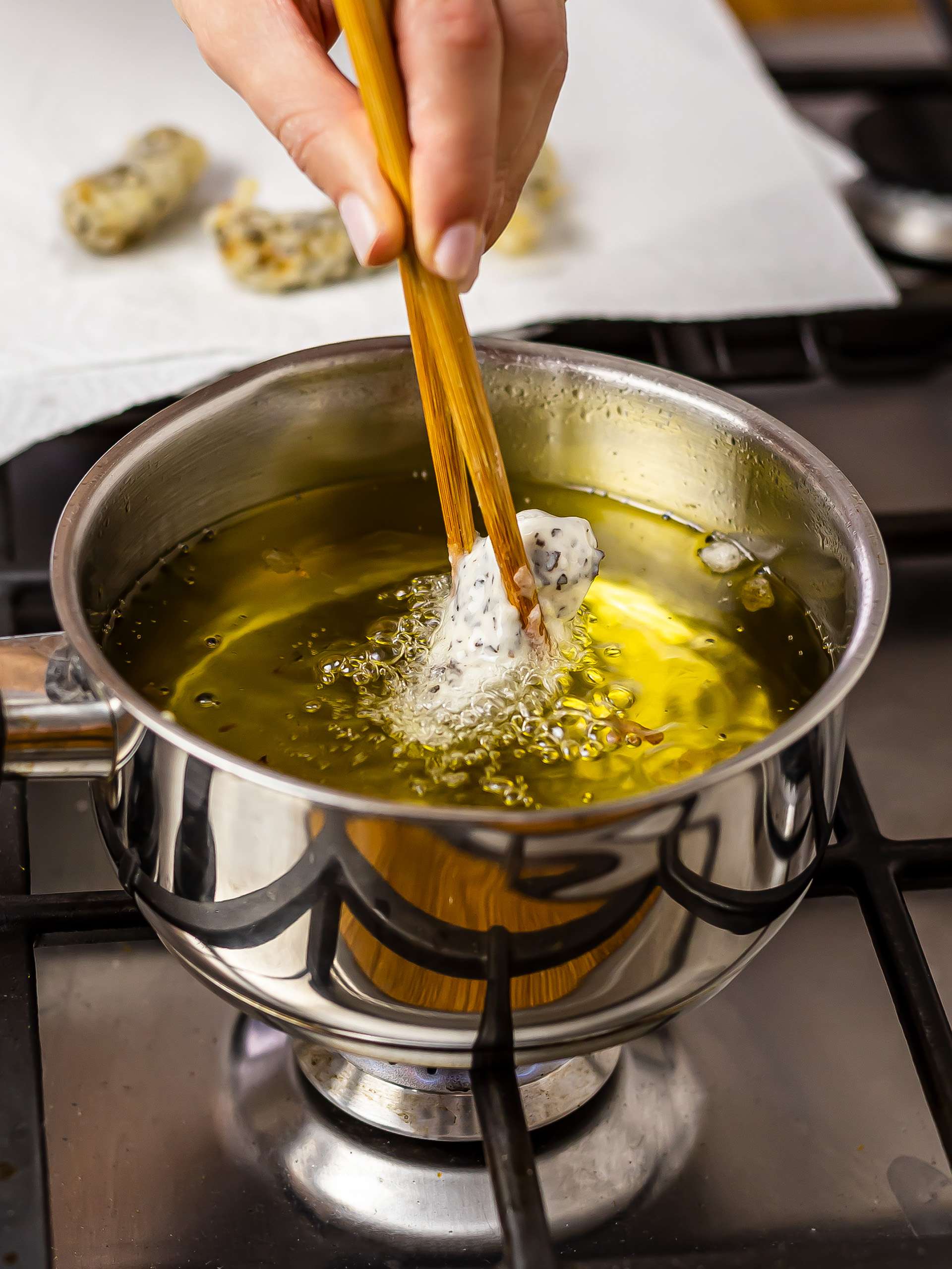 woman frying vegan ebi tempura in a pot with oil