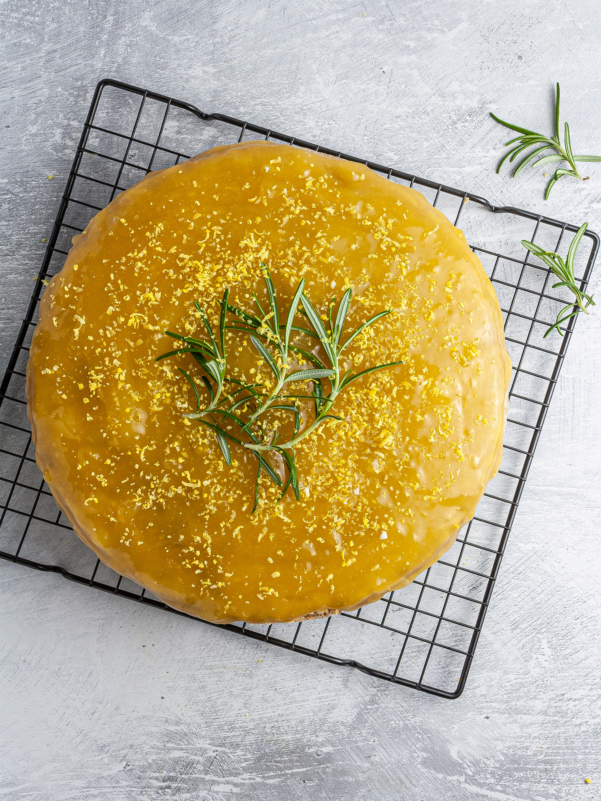 Baked lemon rosemary cake topped with lemon curd