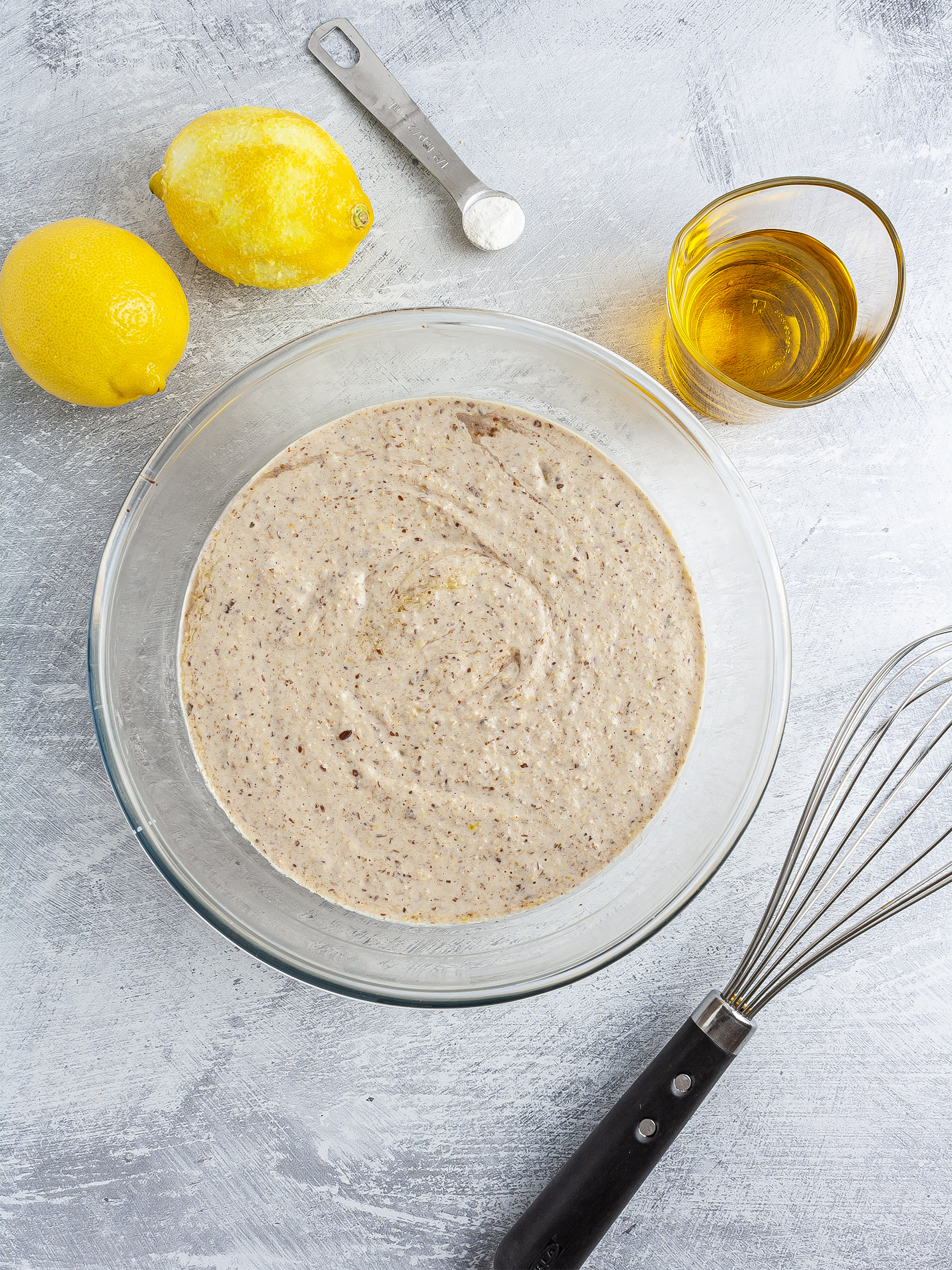 Lemon cake batter with olive oil in a mixing bowl