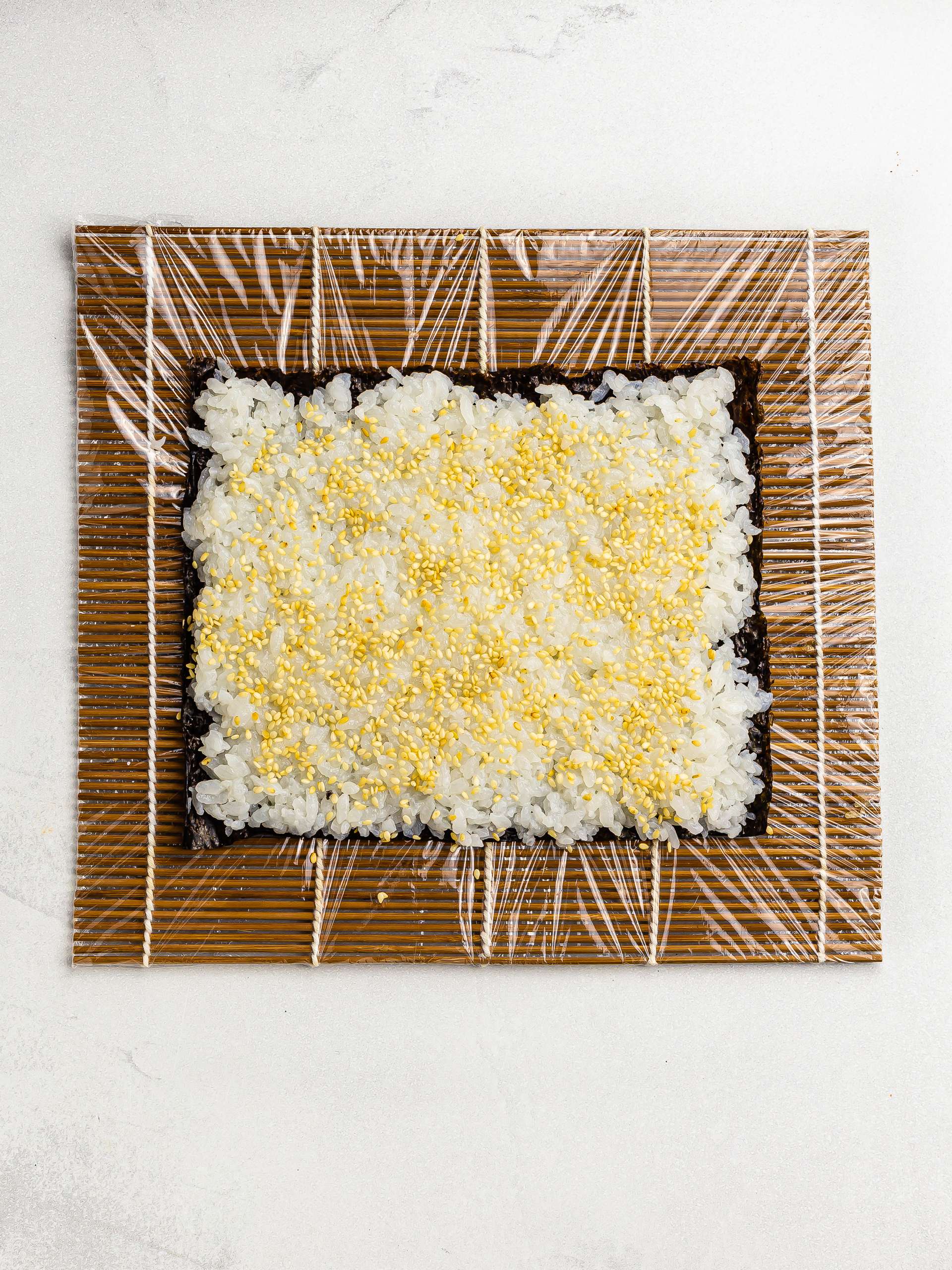 nori sheet with rice and sesame seeds