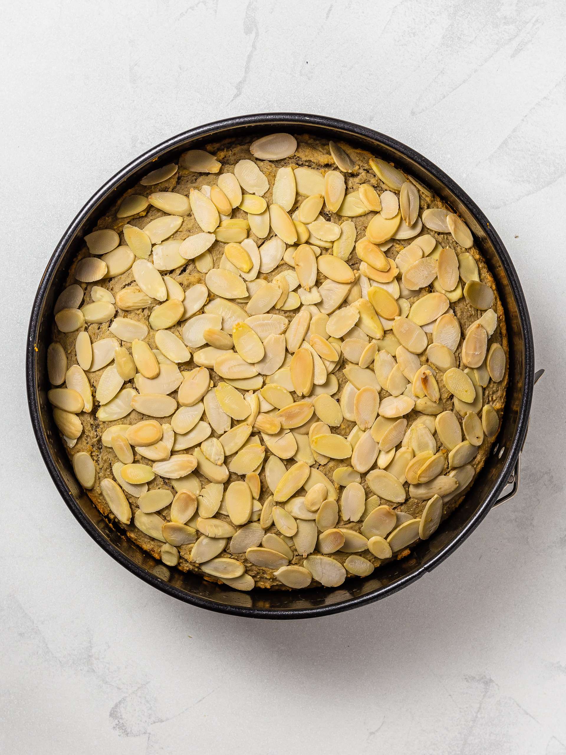 baked gluten-free almond cake in a tin