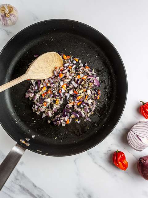 Onion, garlic, and chillies sizzled in a skillet